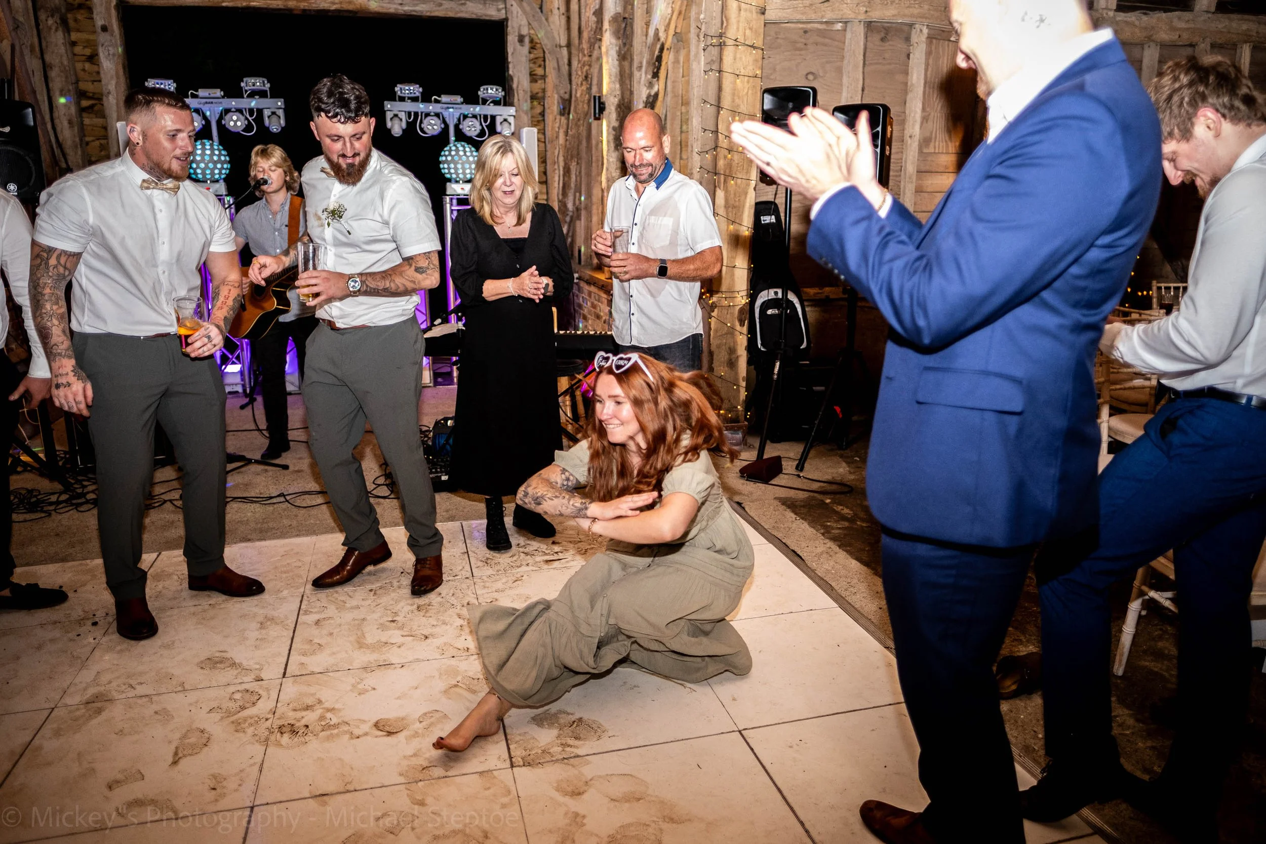 Guests look on as a female guest dances energetically!