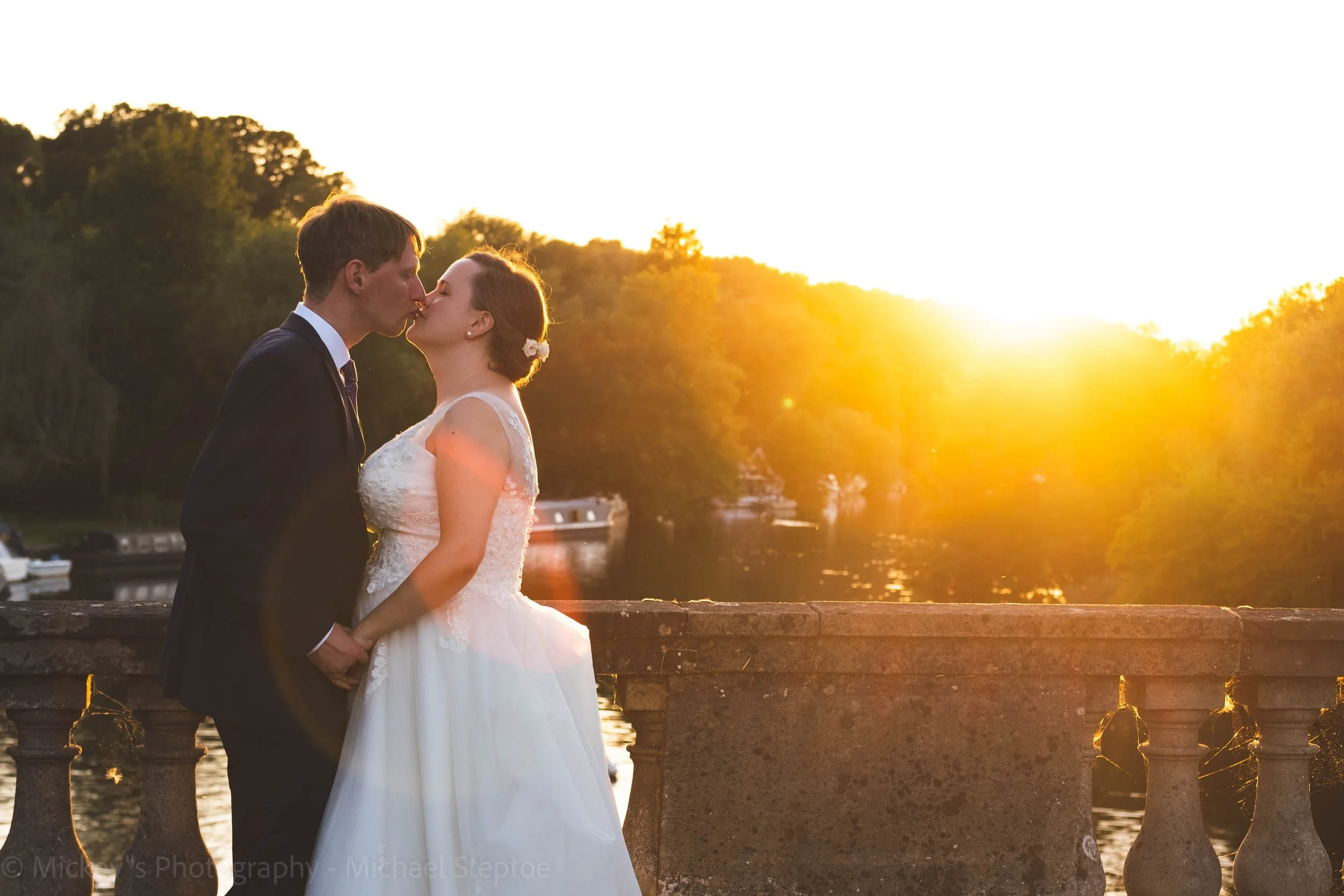 Bride and Groom share an intimate moment on the Shillingford bridge as the sunsets behind them!