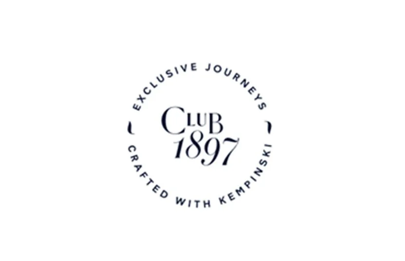 Circular logo with text around it that reads 'Exclusive Journeys Crafted with Kemptinski,' and in the center, 'Club 1897' in stylized font.