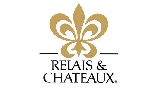 Relais & Chateaux logo with a gold fleur-de-lis design.