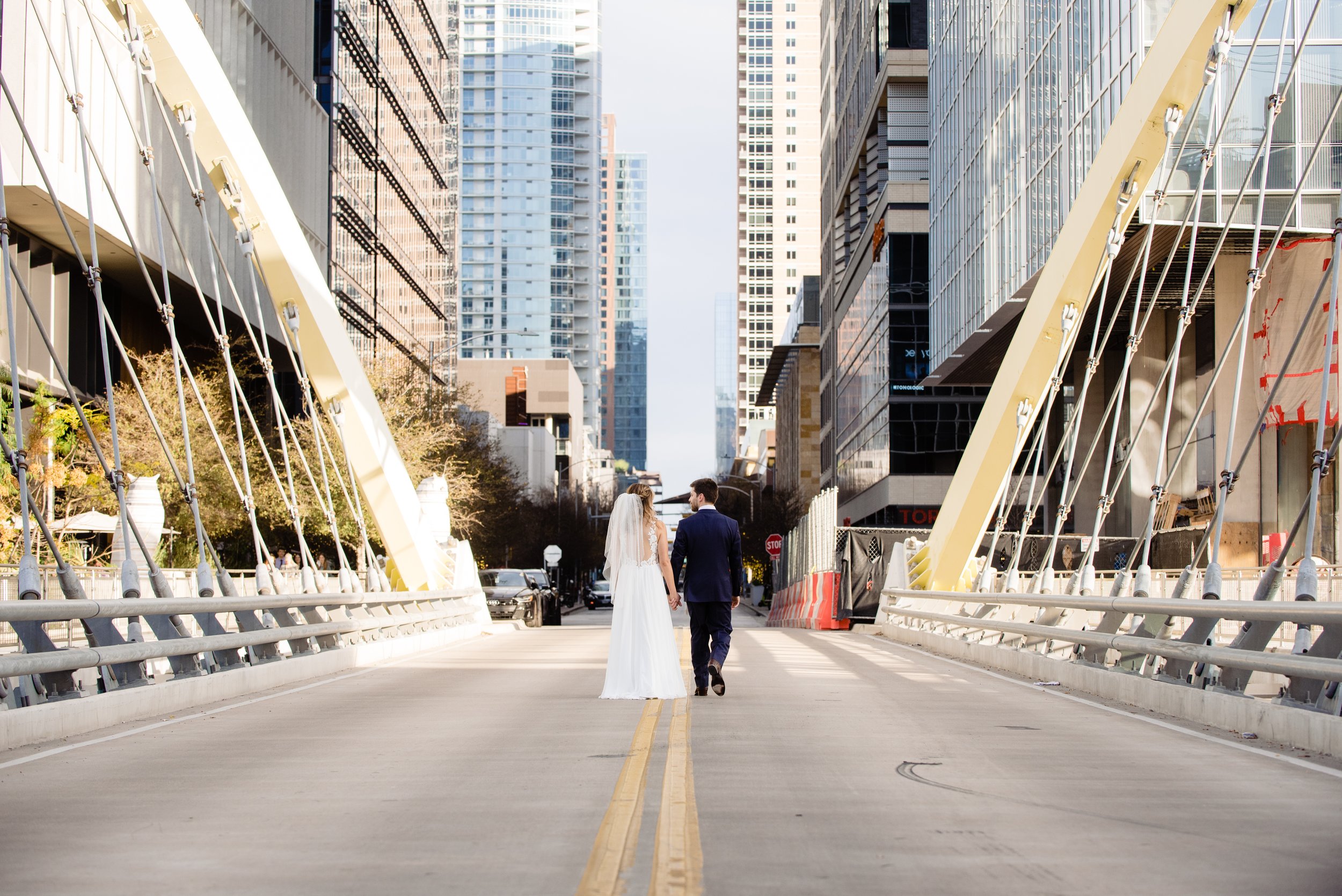downtown-austin-wedding-couple-walking-butterfly-bridge-photo