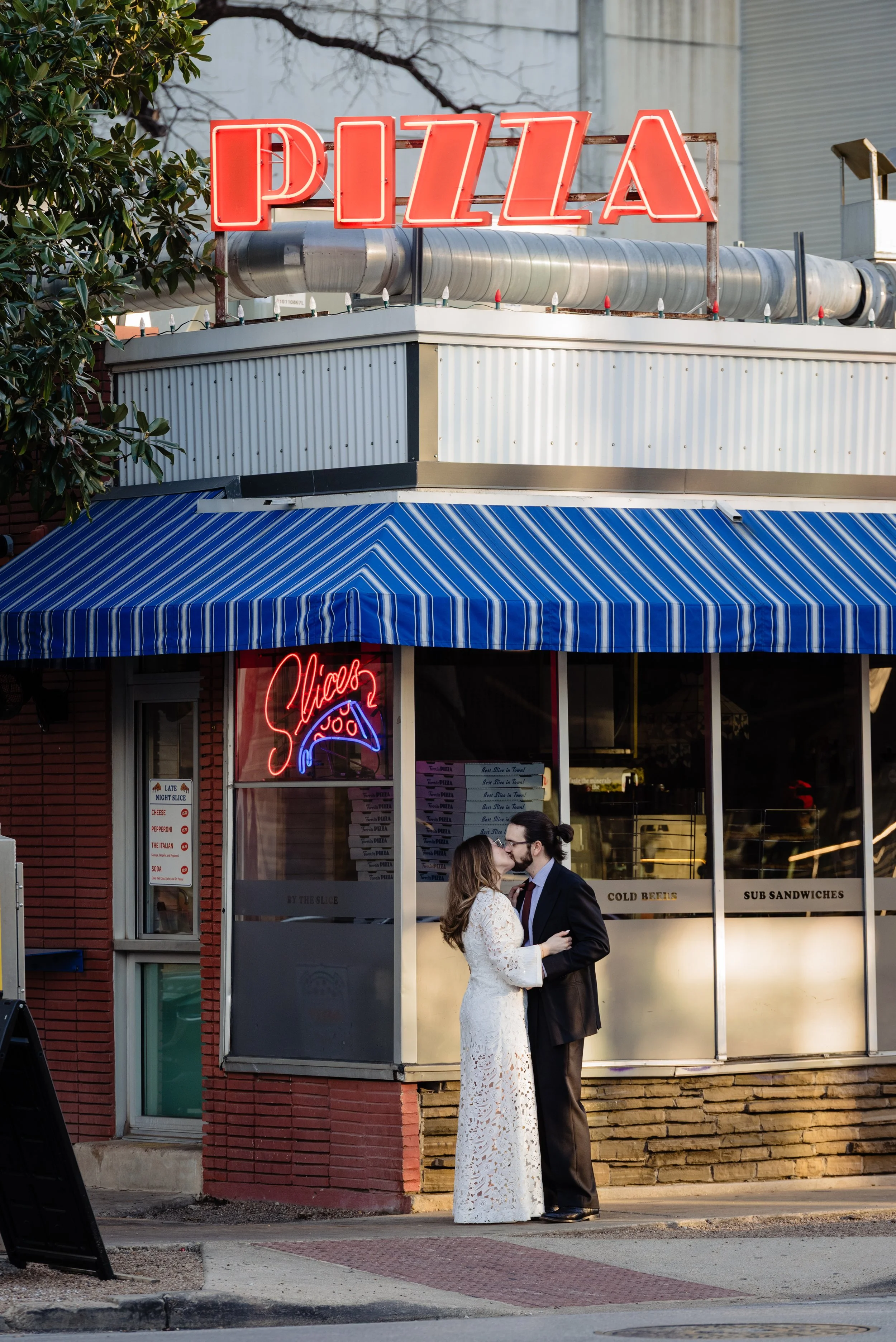 Newlyweds enjoying a pizza parlor after their Austin elopement 