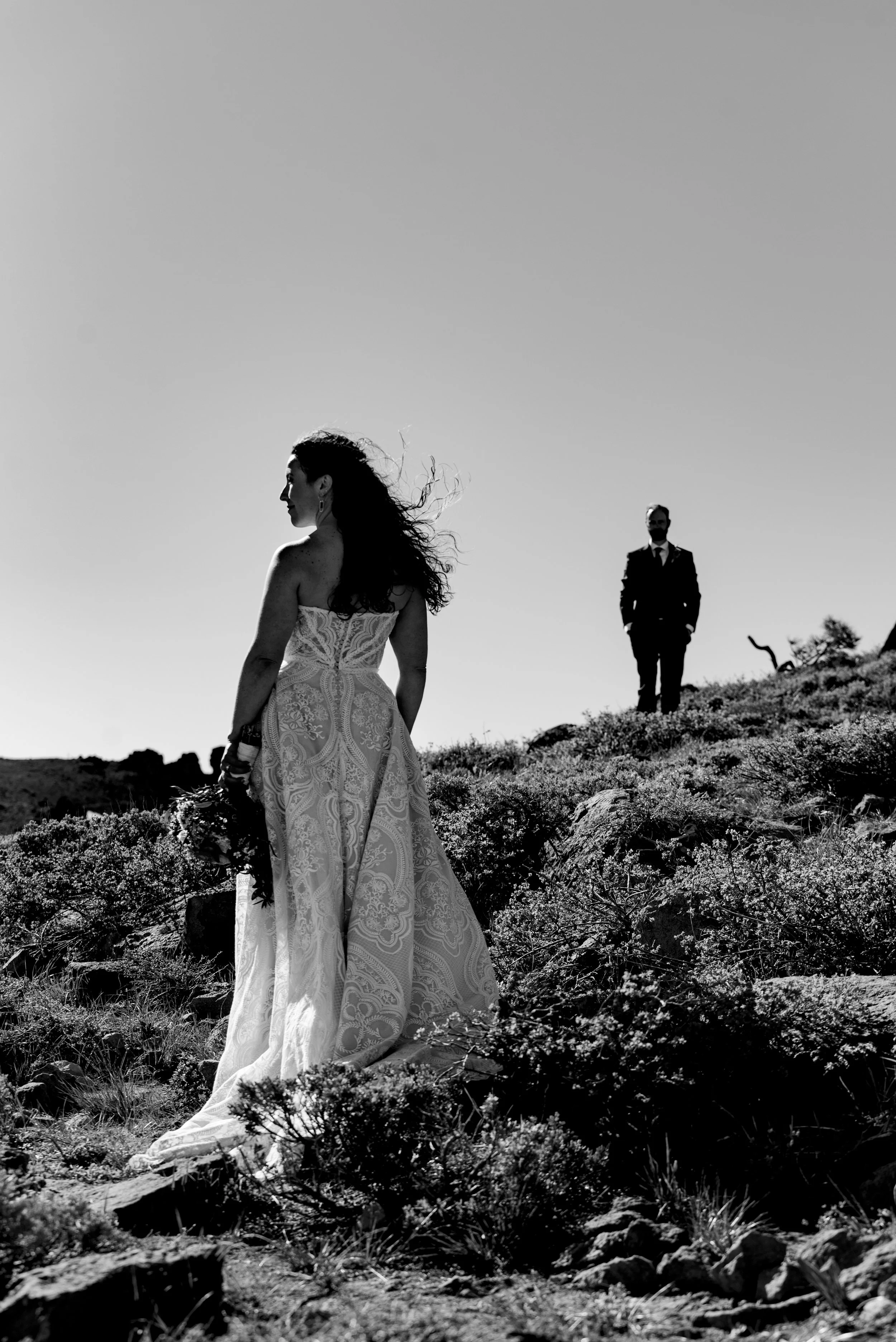  Black and white image of bride and groom on mountain 