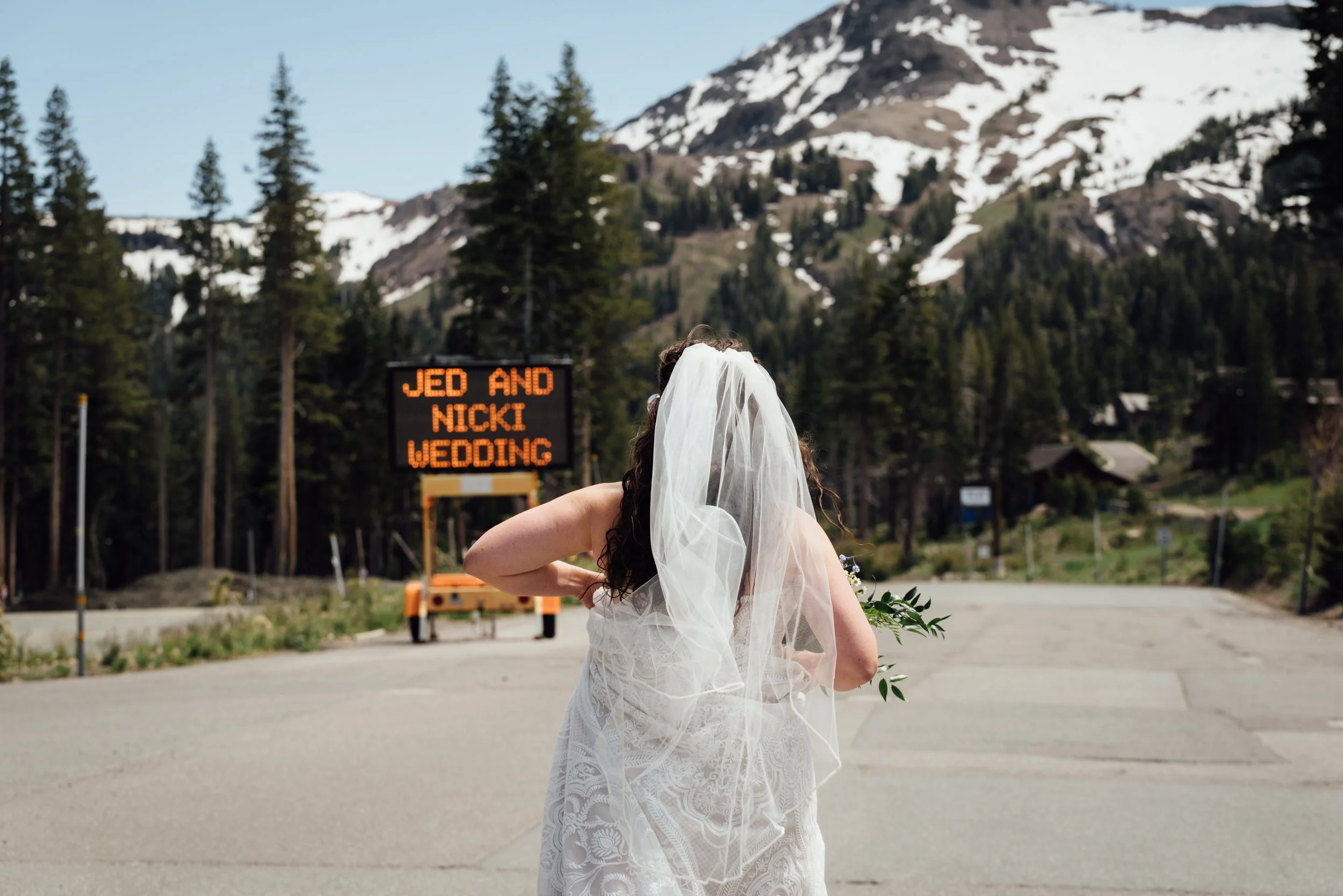 Bride reading road sign on wedding day 