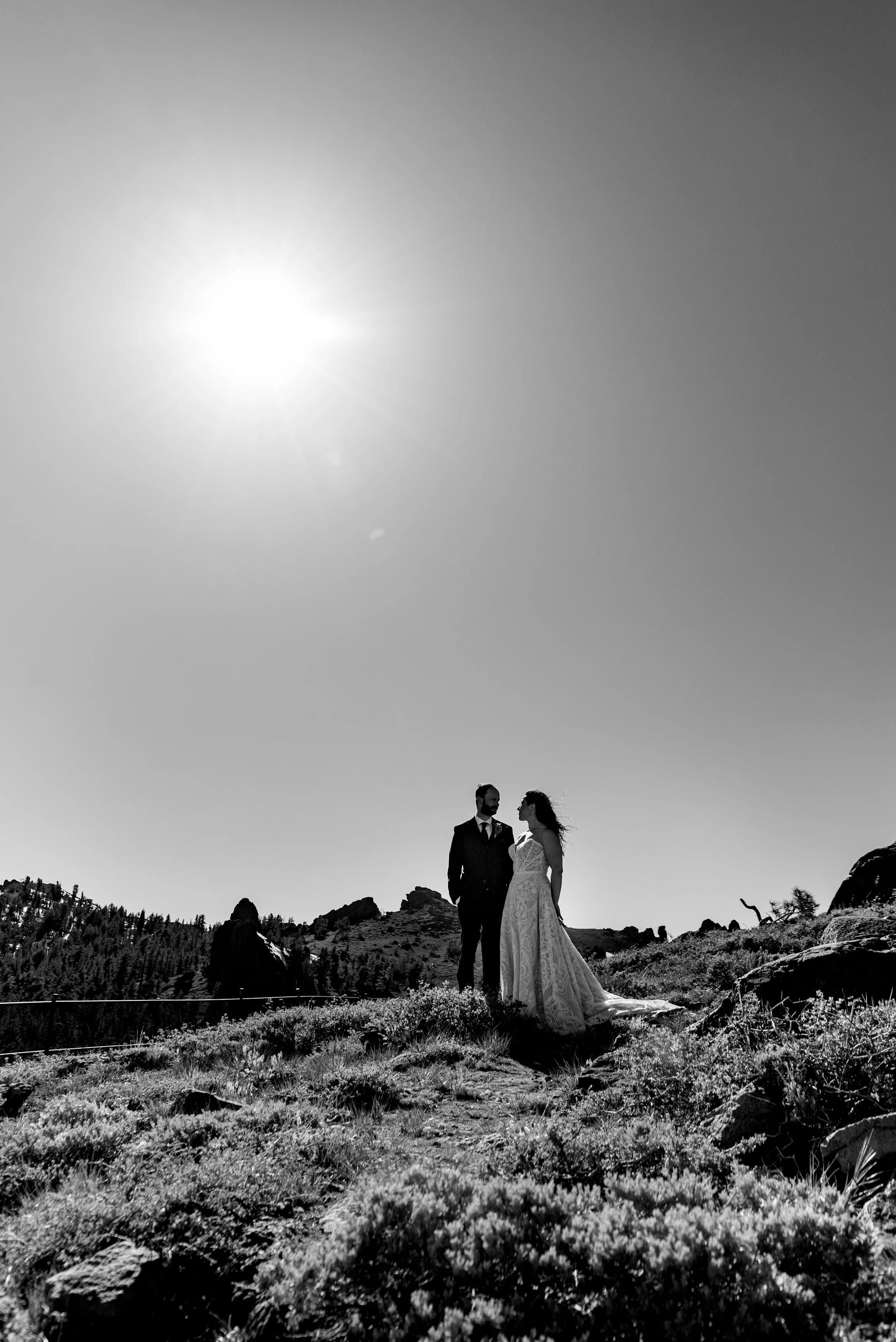  Black and white image of newlyeds atop mountain 