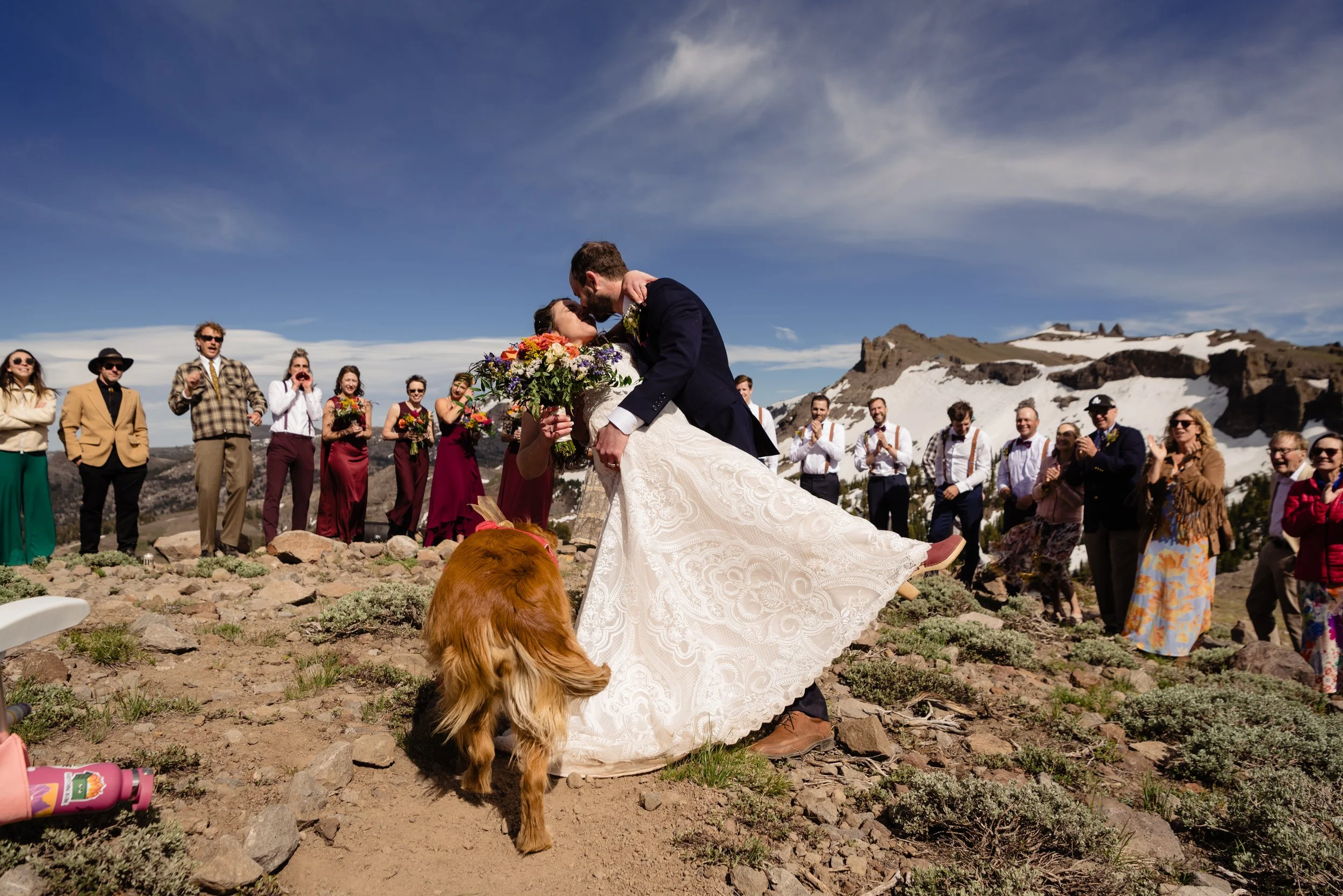 Photographer taking image of rescue dog with her parents at their adventure wedding