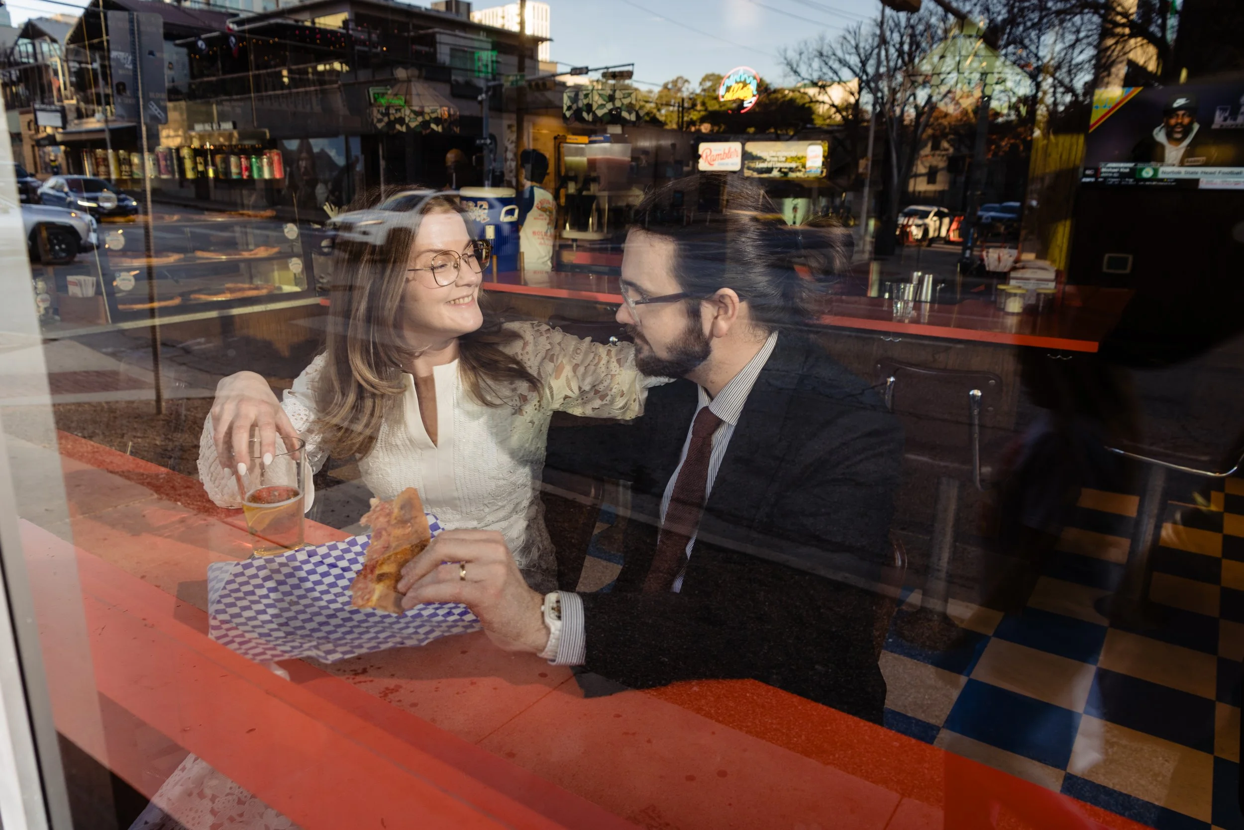 Newlyweds enjoying pizza and beer after their elopement in Austin