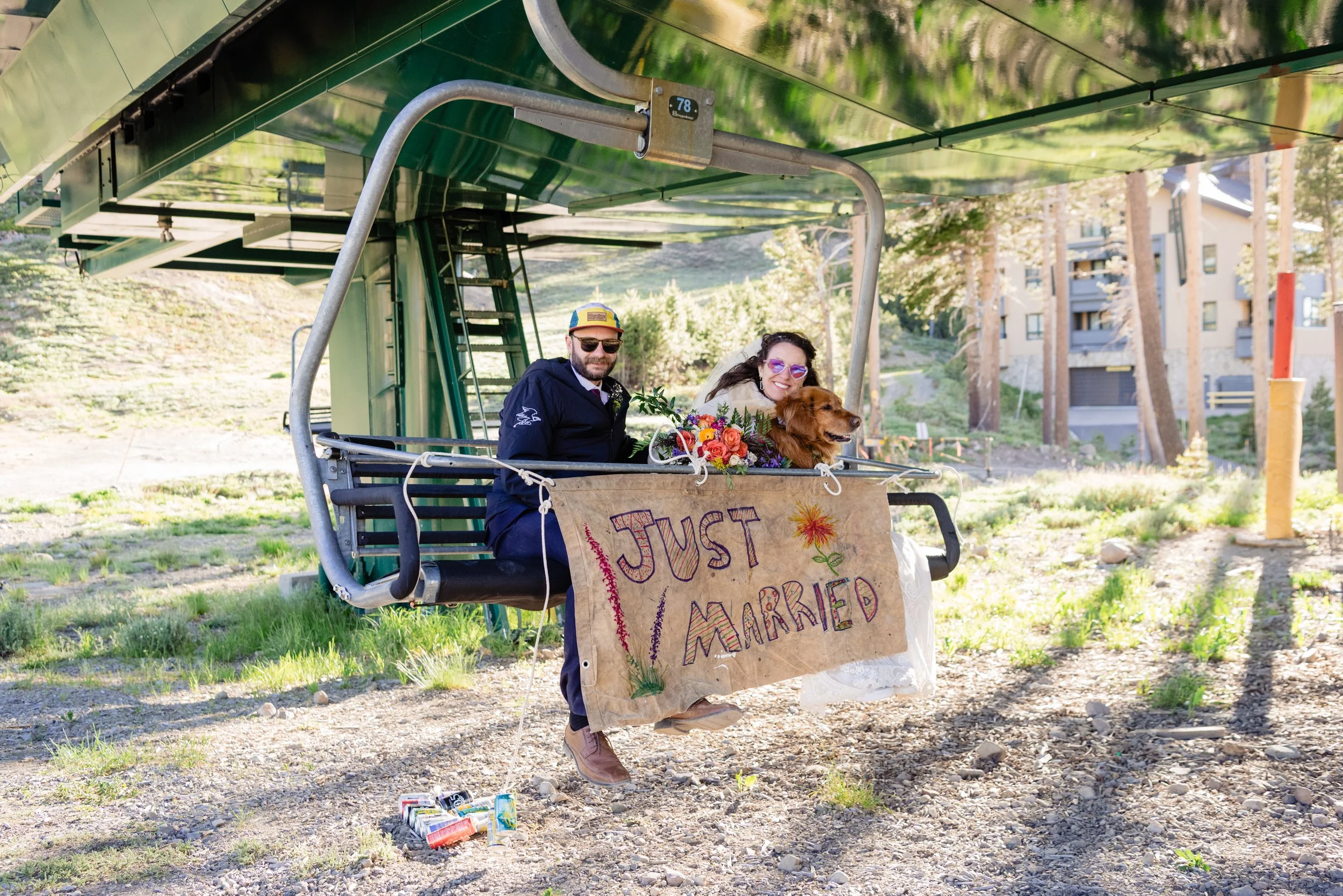 Just married couple with their dog on ski lift