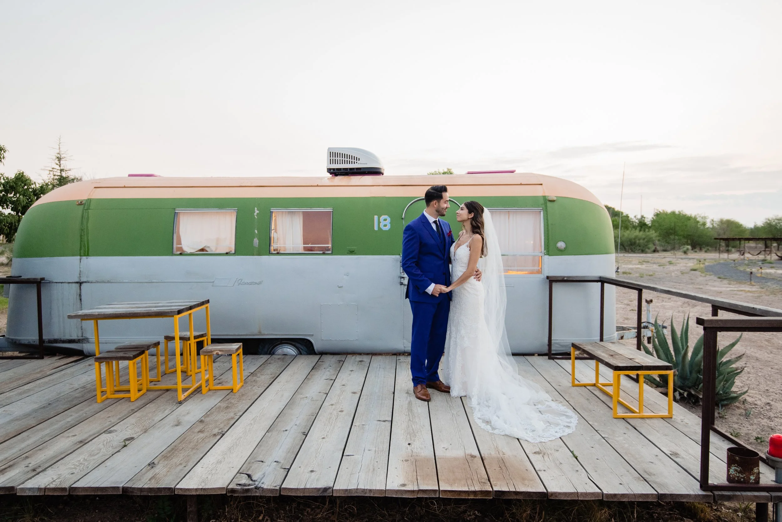 A sweet couple outside an airstream trailer getting married and having pics taken by an Austin elopement photographer