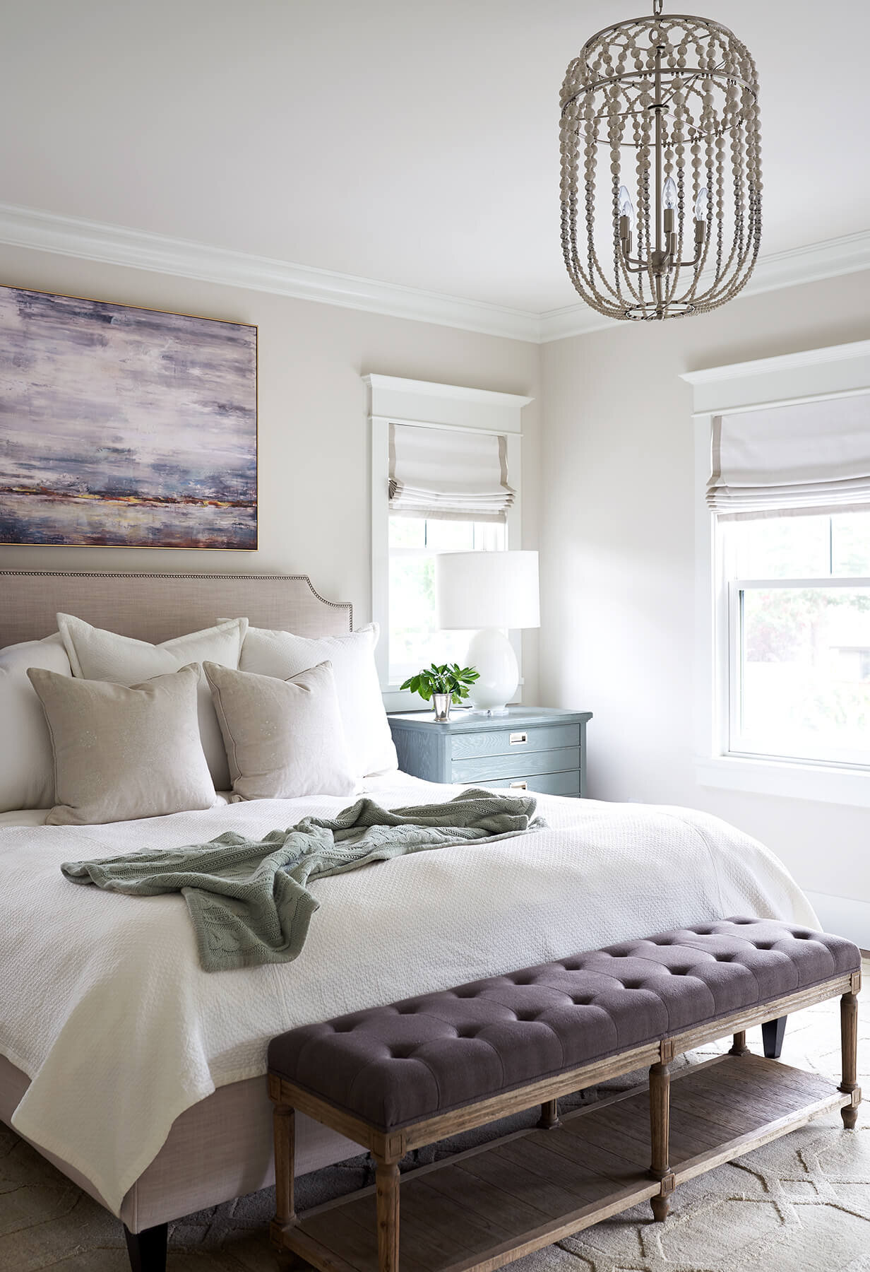 Master bedroom with painting above bed.