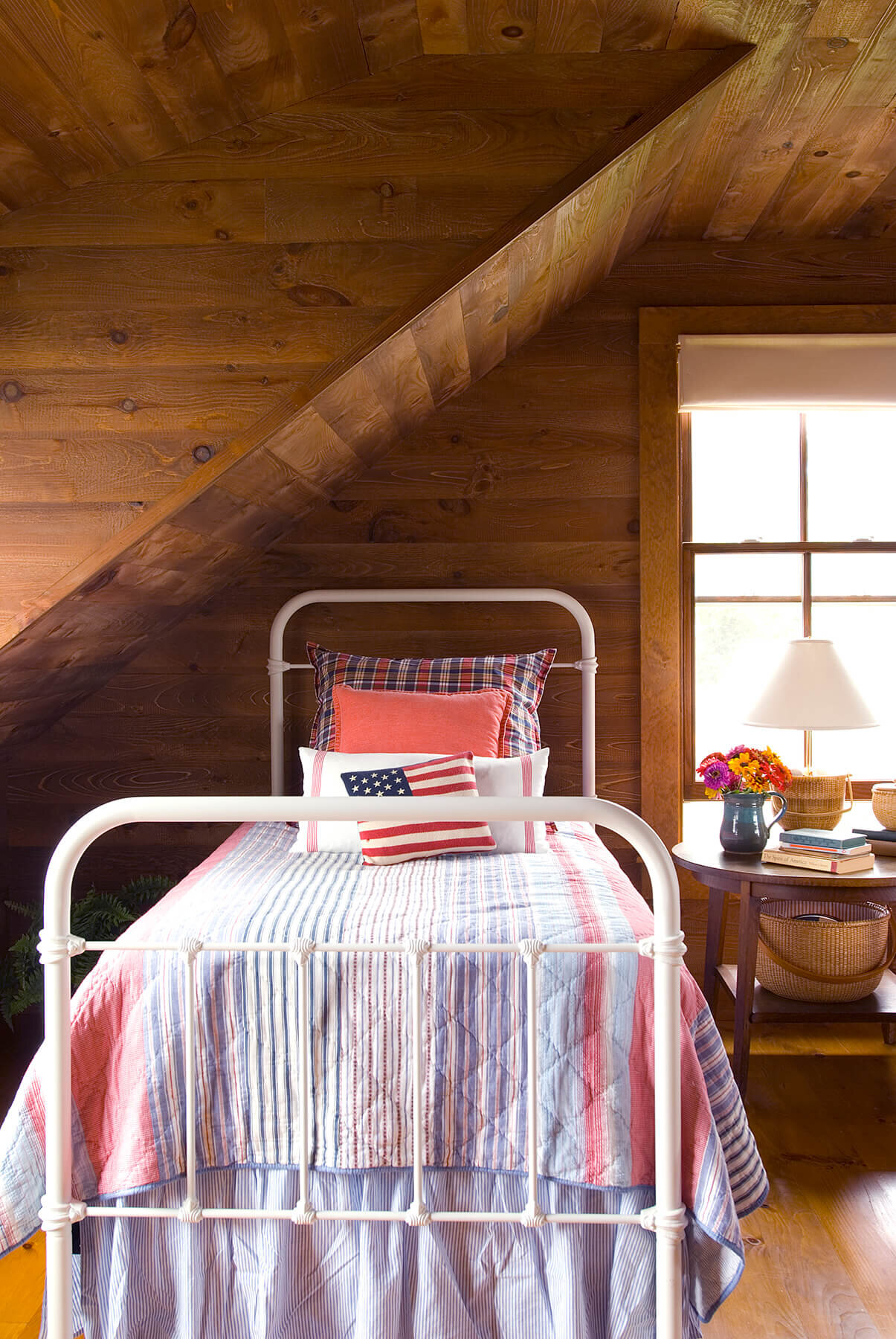 Campy guest bedroom with old pine walls.