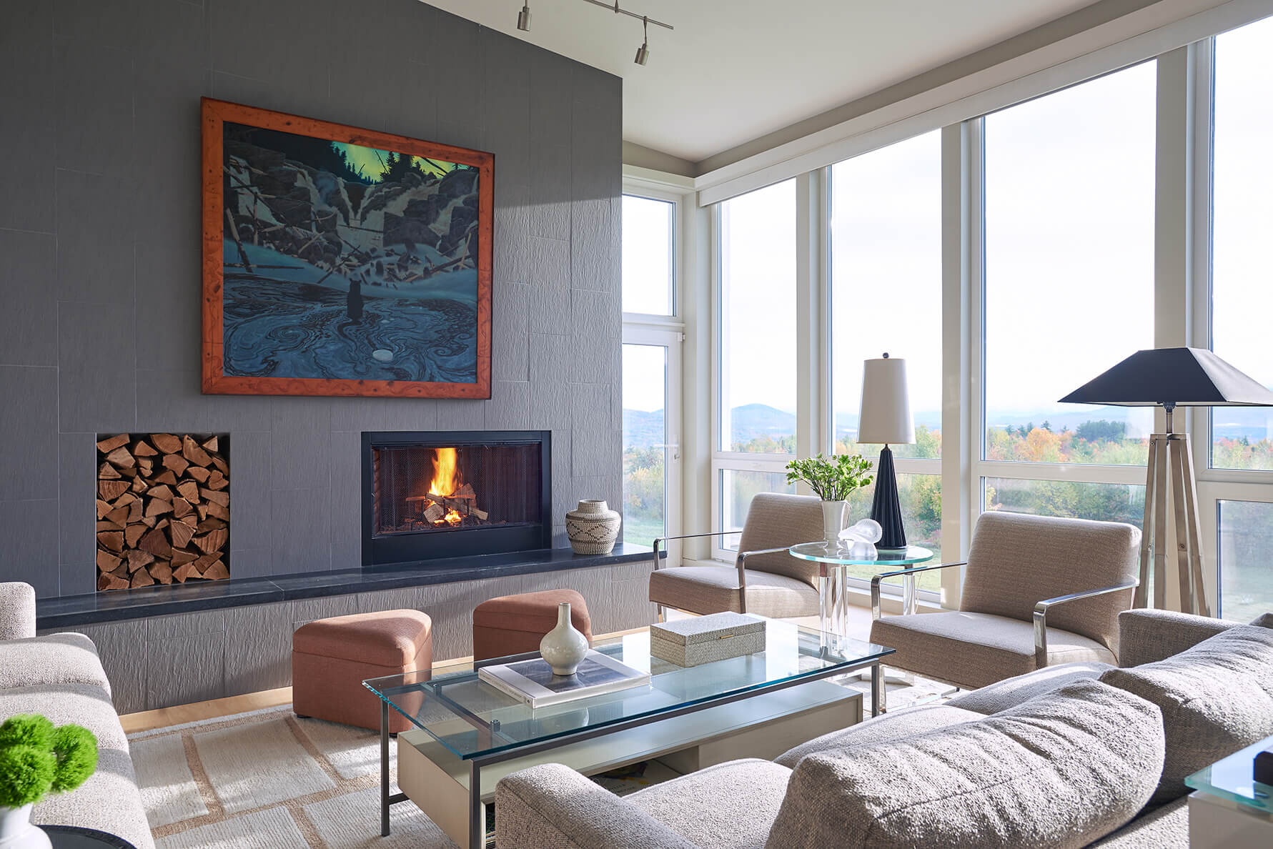 Modern Living room with slate wall with fireplace and plate glass window overlooking the White Mountains.