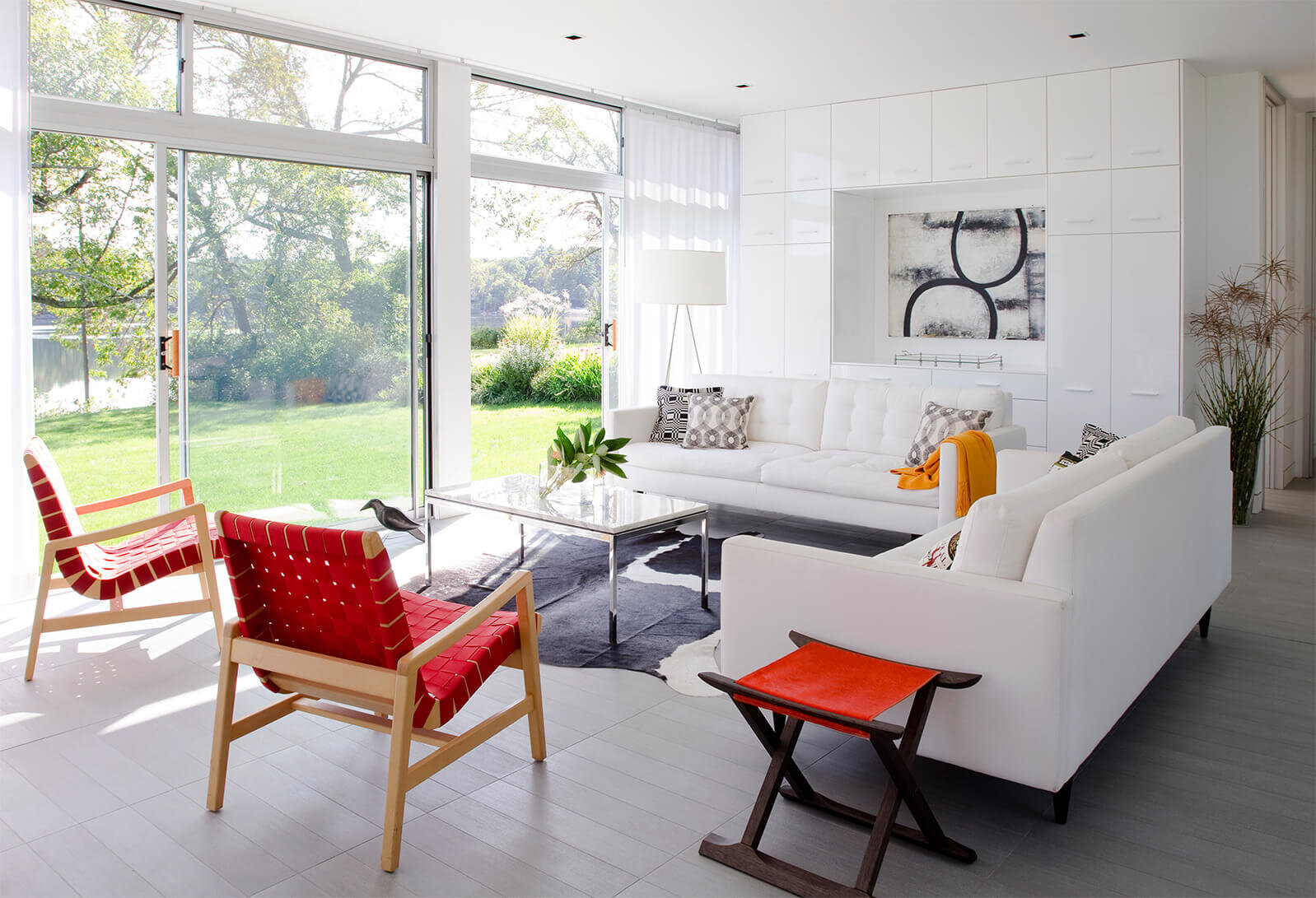 Interior mid century modern living room with orange chairs.
