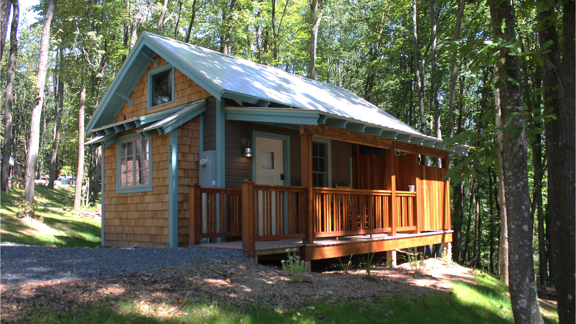  ADA compliant tiny home with ground-level porch and outdoor shower on the porch.  