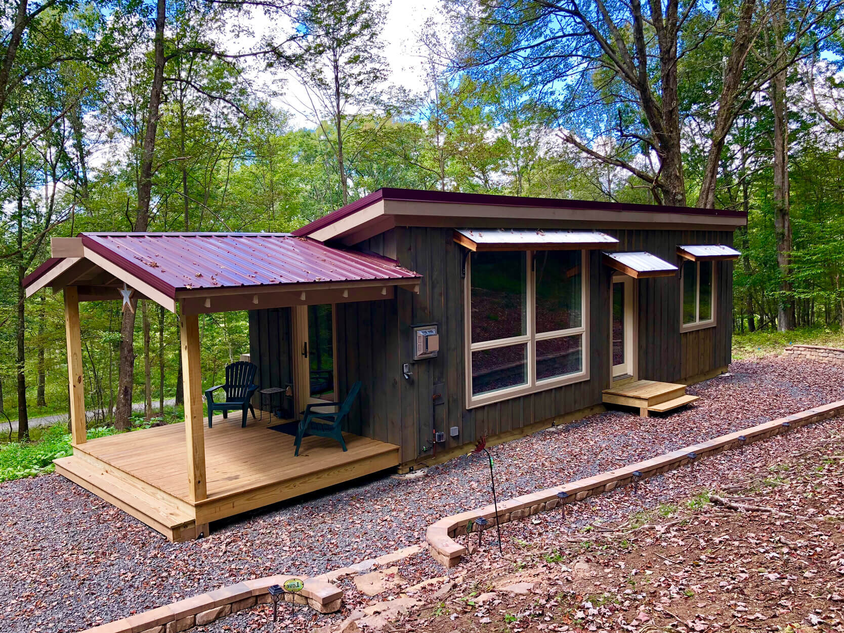  Tiny house with a red metal roof built in Maryland. 