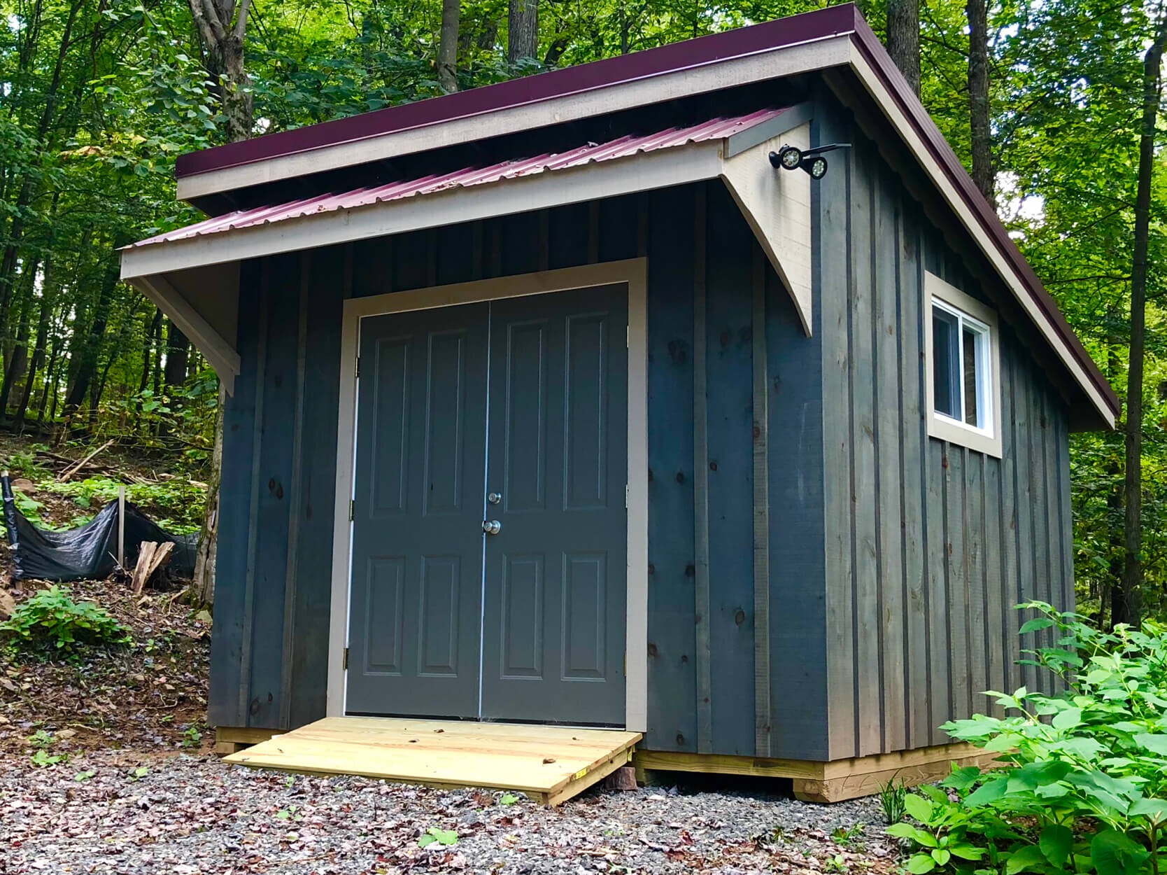  Matching shed/garage for this small home is great for keeping yard equipment and tools.  