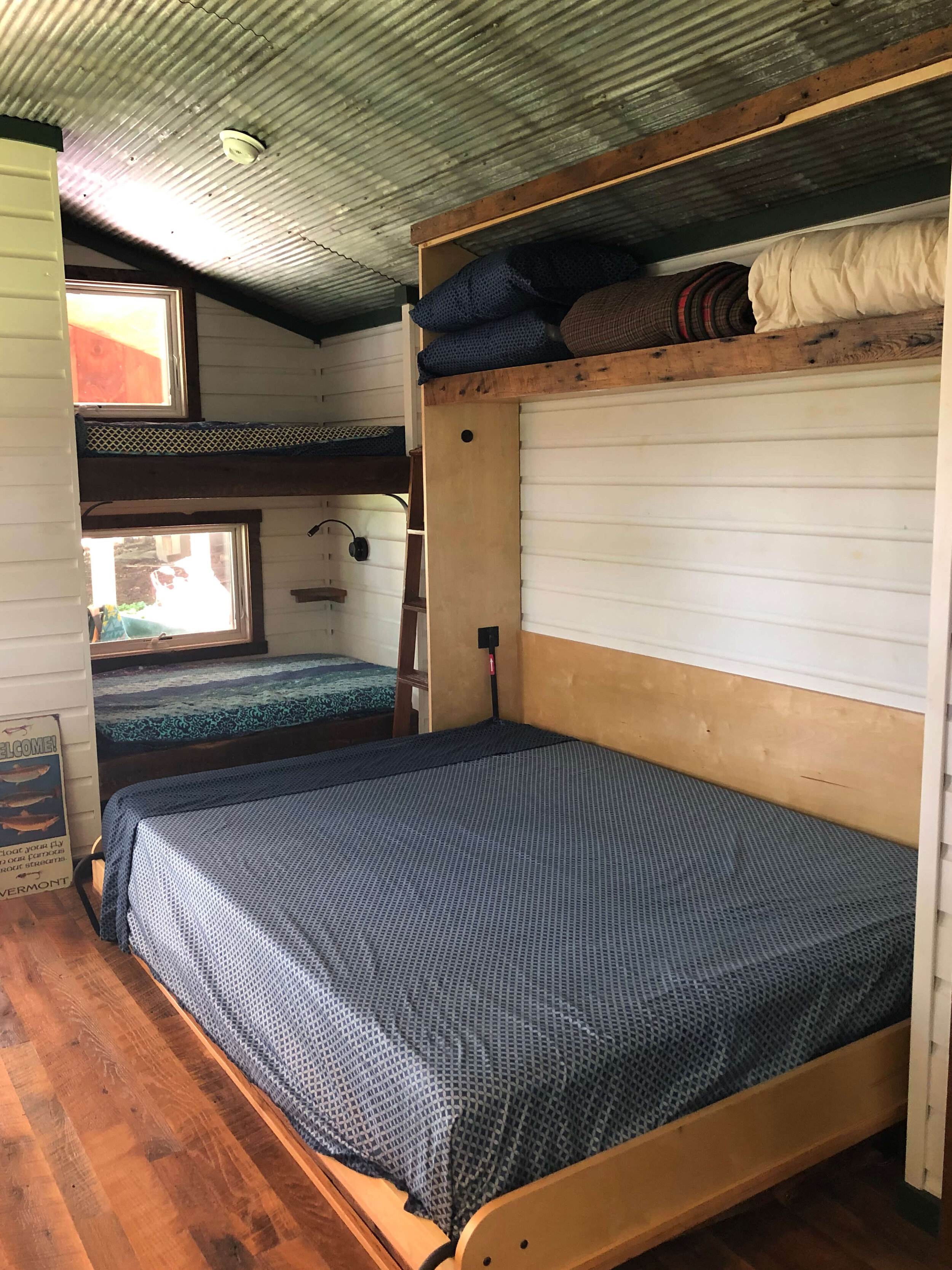  The bed is now fully set up and ready for use in this tiny house. 