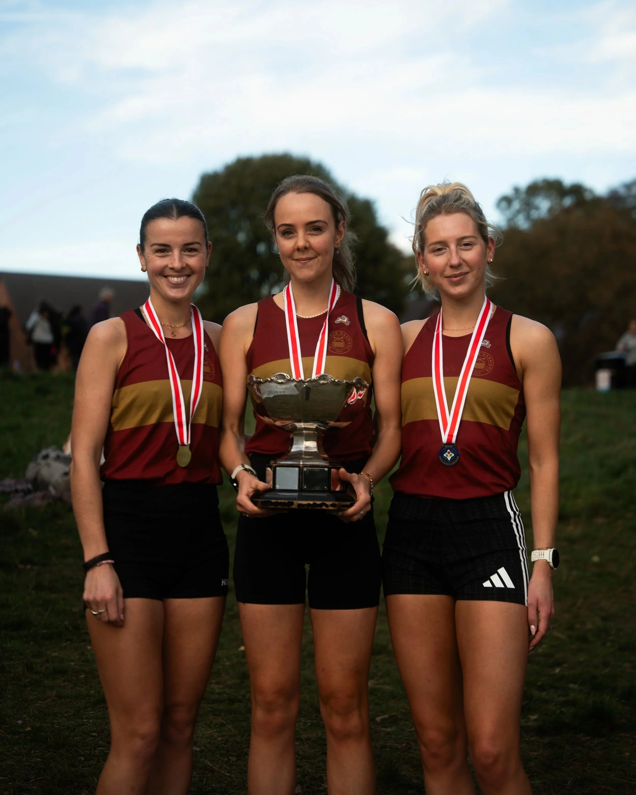 Three Belgrave women holding the national cross country relays trophy.jpg