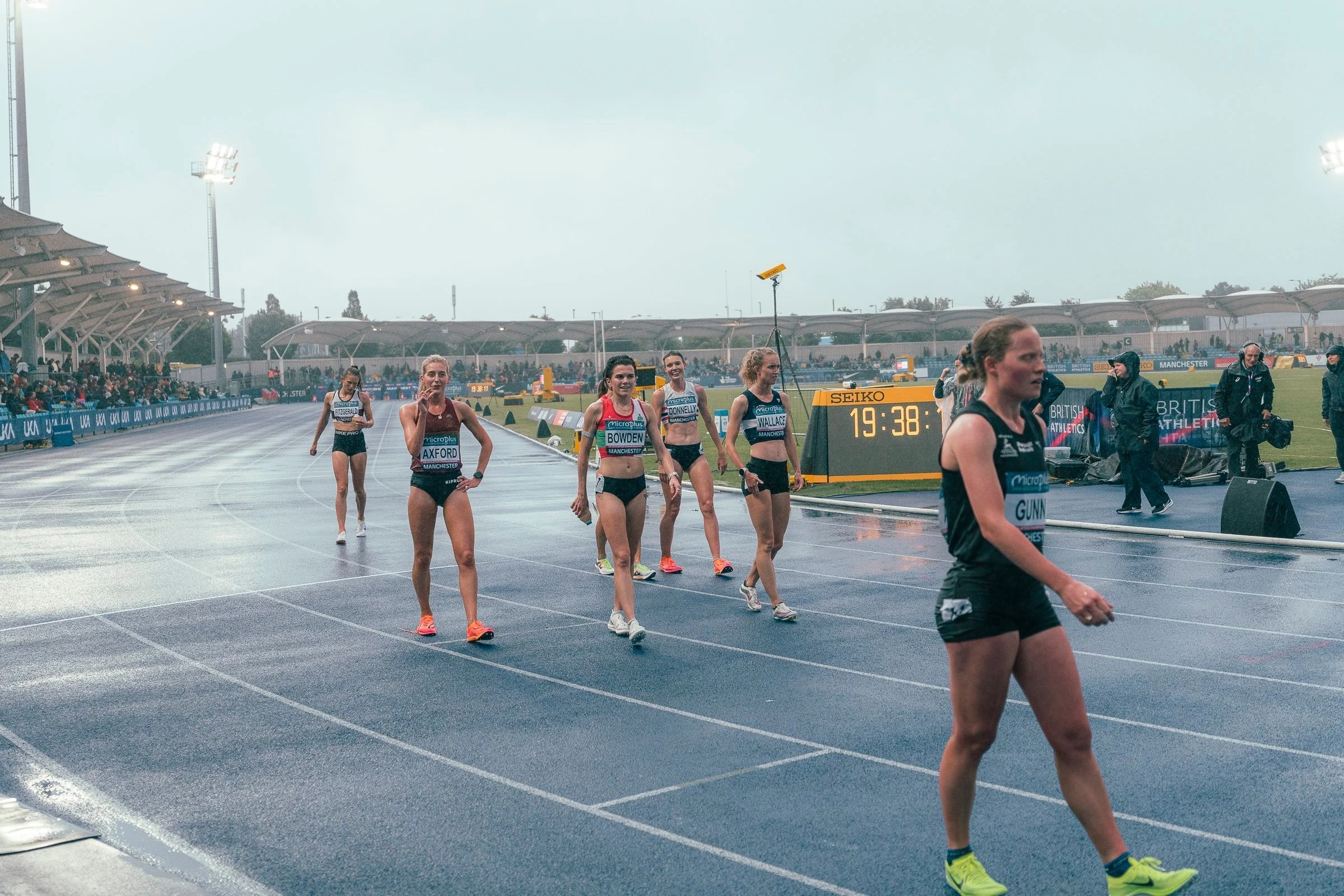Belgrave athletes walking off a wet track after a race at a British Athletics meeting.jpg