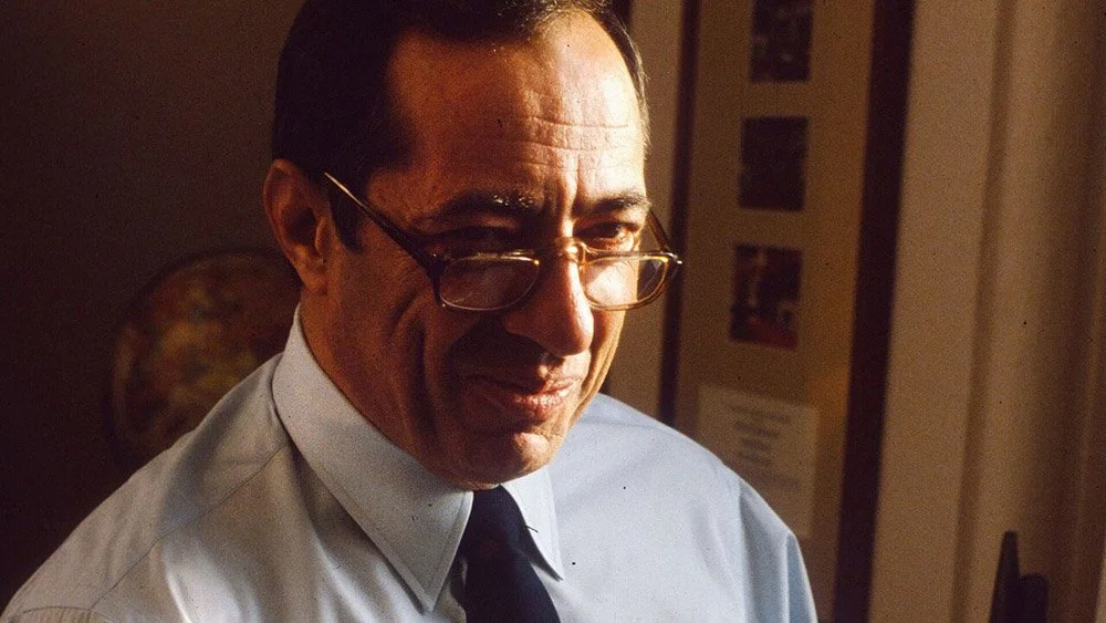 photo of Mario Cuomo smiling and appearing thoughtful