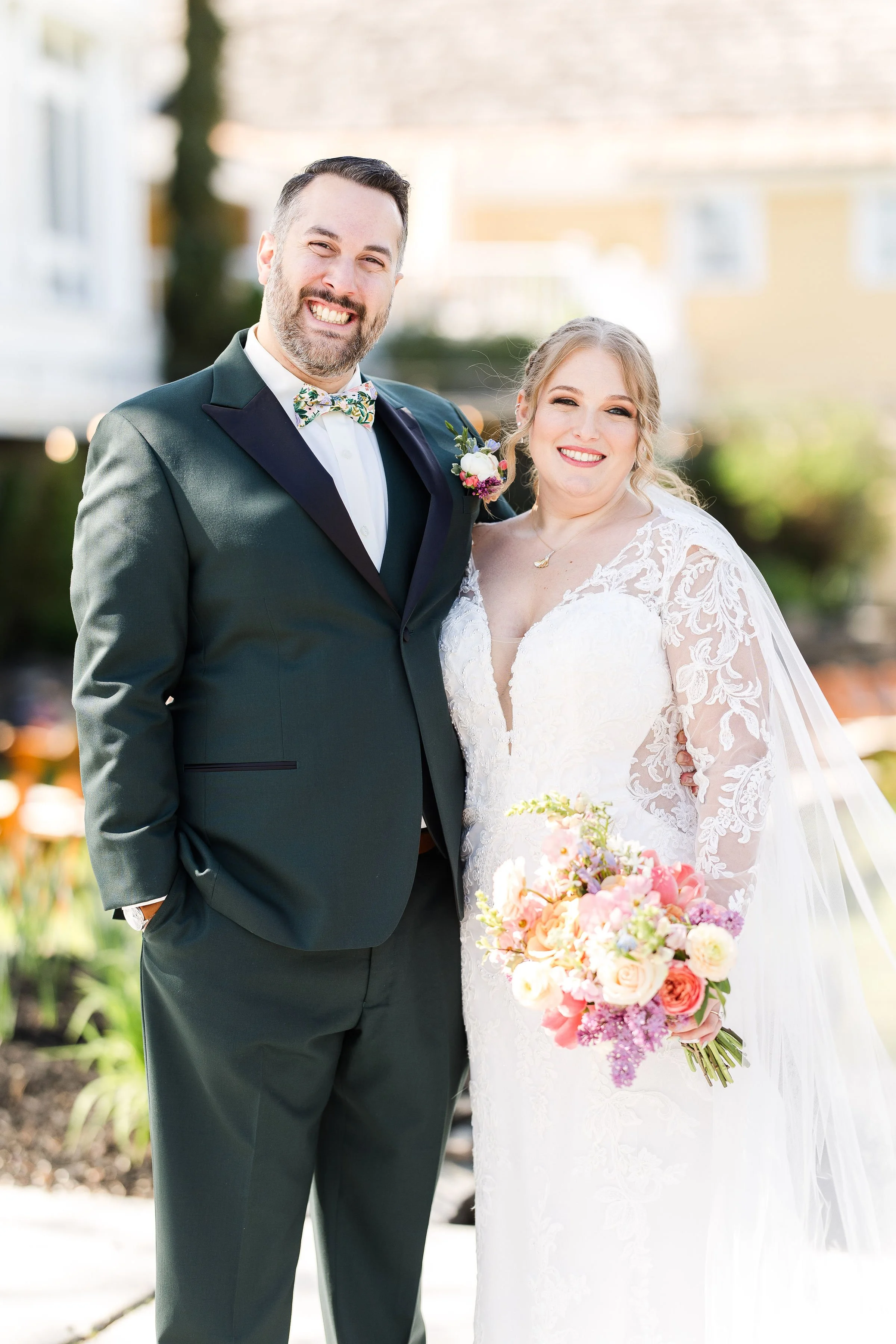 bride and husband holding flowers after getting married in new hampshire with full glam makeup, new england wedding  makeup artist