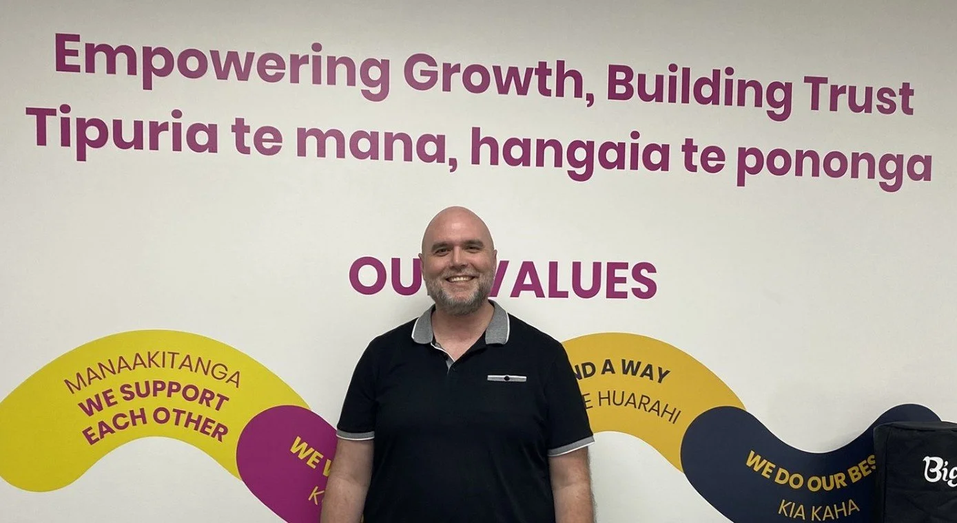 Anthony in front of ConneXu's Purpose and Values statements