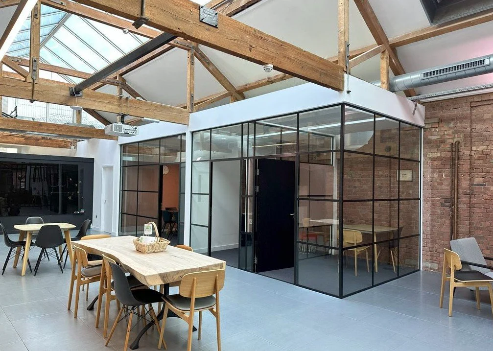 large open plan renovated office with wooden beams ready for a noise assessment