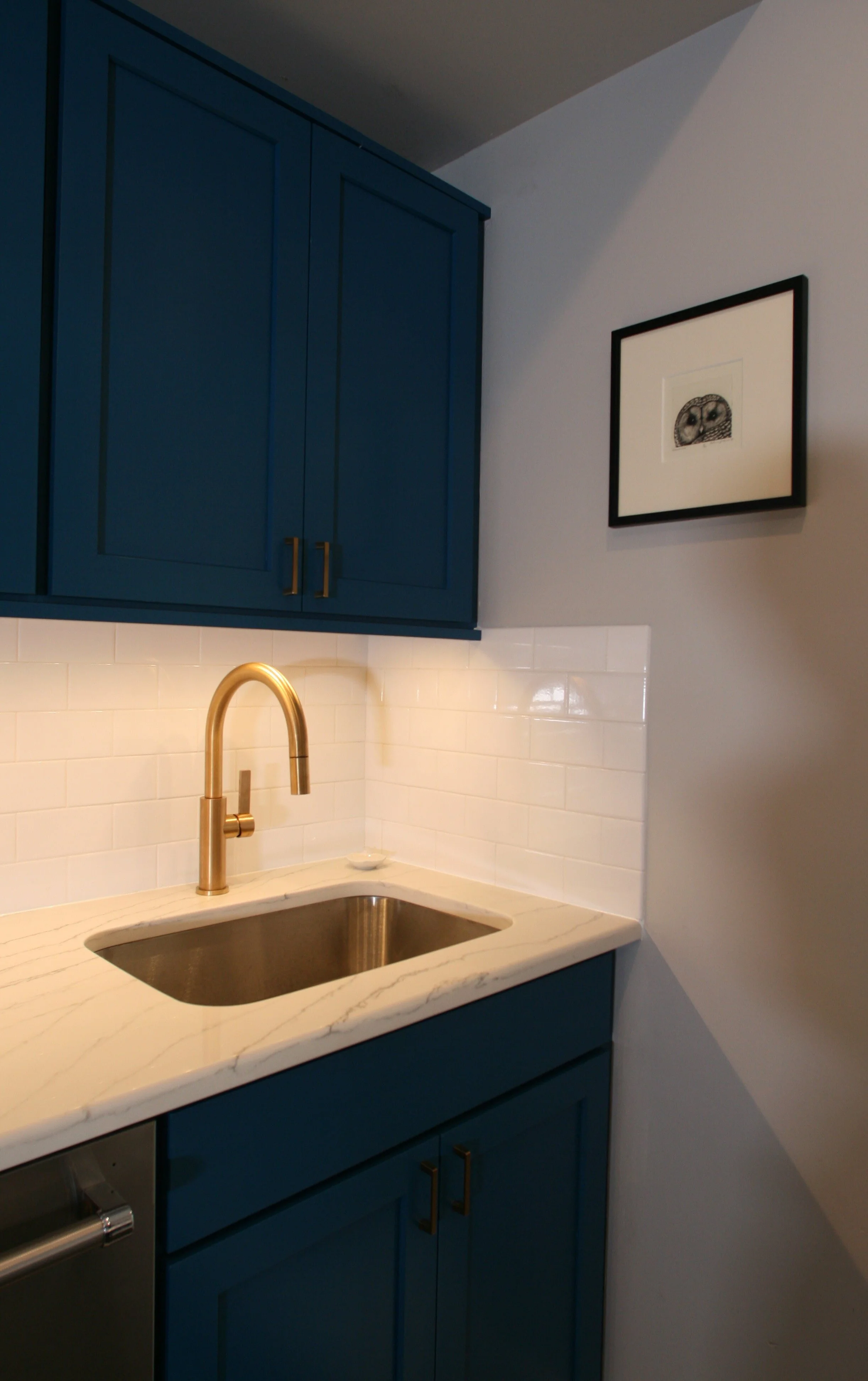 Kitchen Remodeling Example _ Interior Designer in Hoboken NJ - LM Designs White Subway Tile Blue Kitchen Cabinetry Gold sink