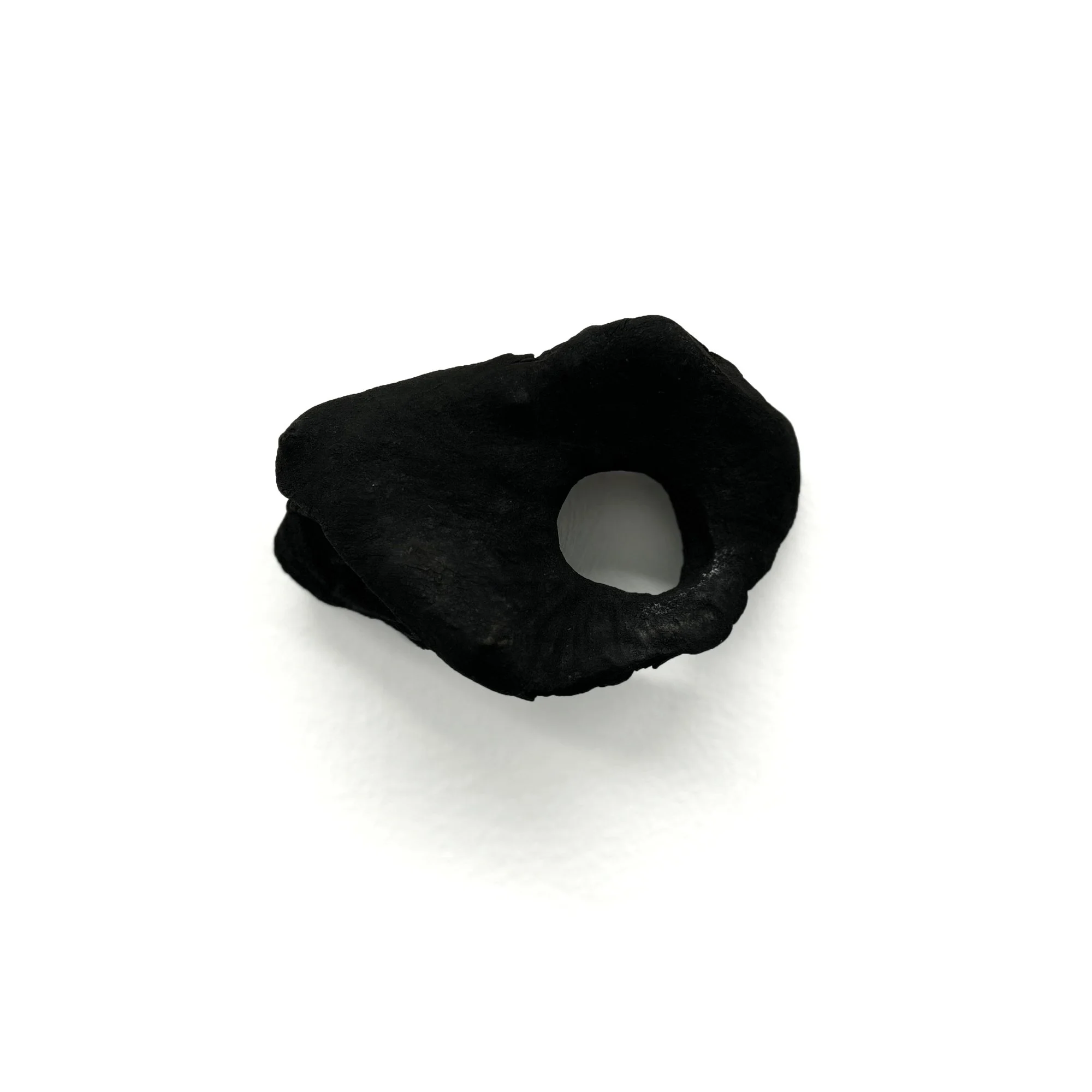    Half Mask , 2022 8 x 12 x 5 cm.  Burned wood, charcoal, ink, ashes   Image by  Alena Schmick .      