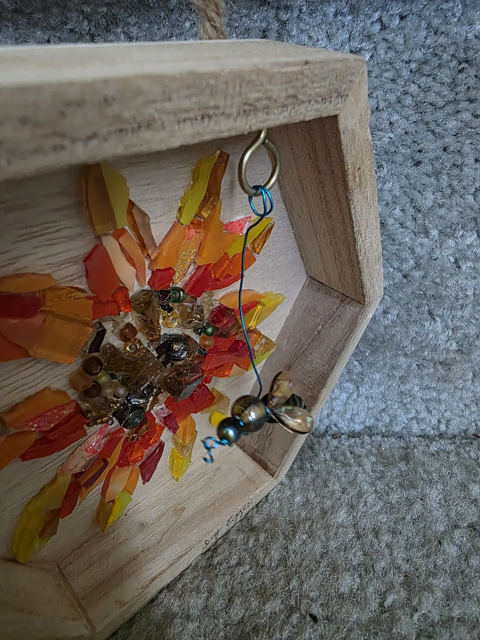 Artwork: wooden hexagon shaped frame around glass sunflower, honeybee