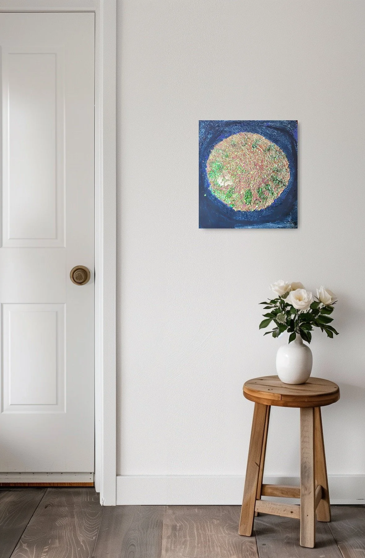 artwork: blue background, glittering white blue circle resembling a diamond on a wall