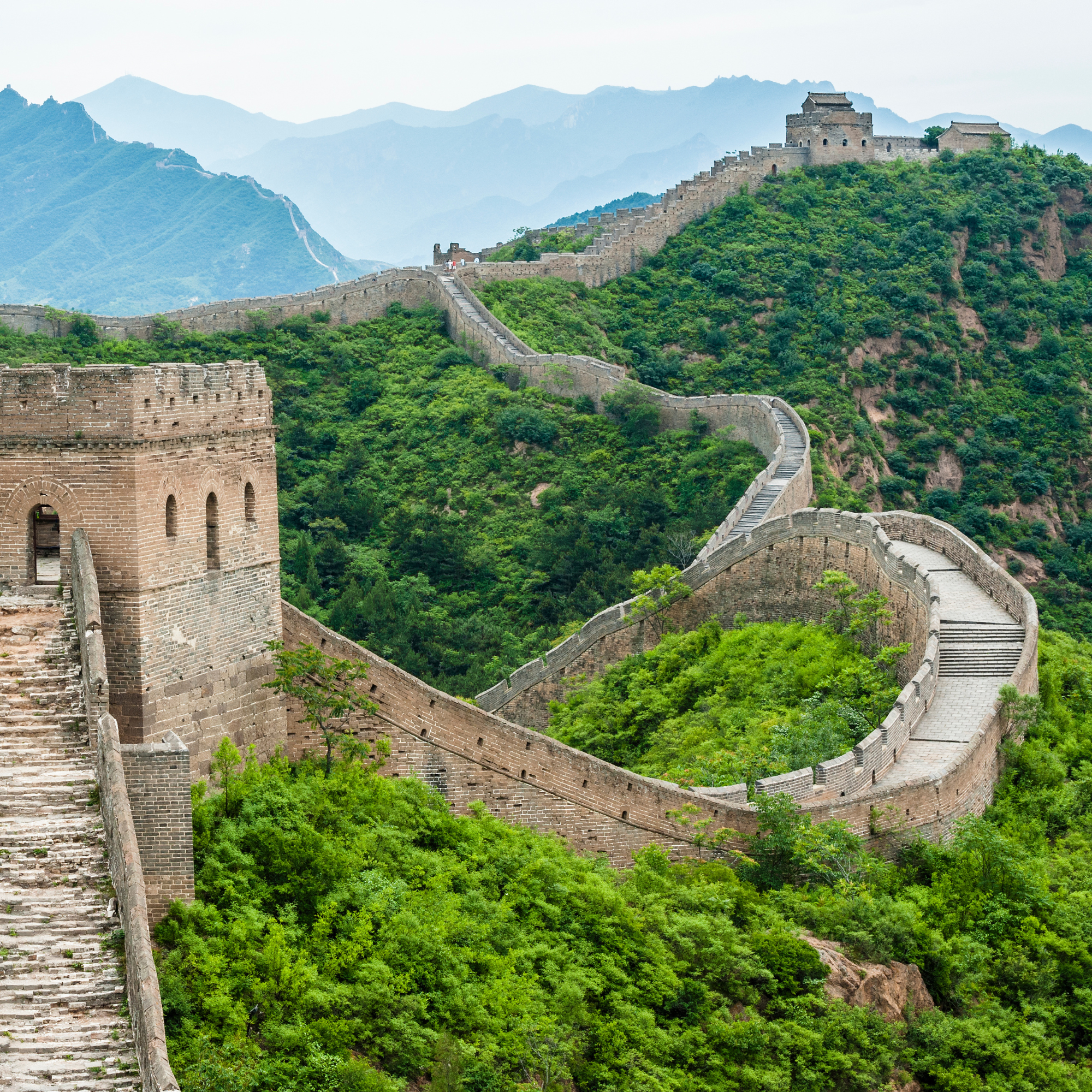 Depicts the Great Wall of China winding on mountaintops.