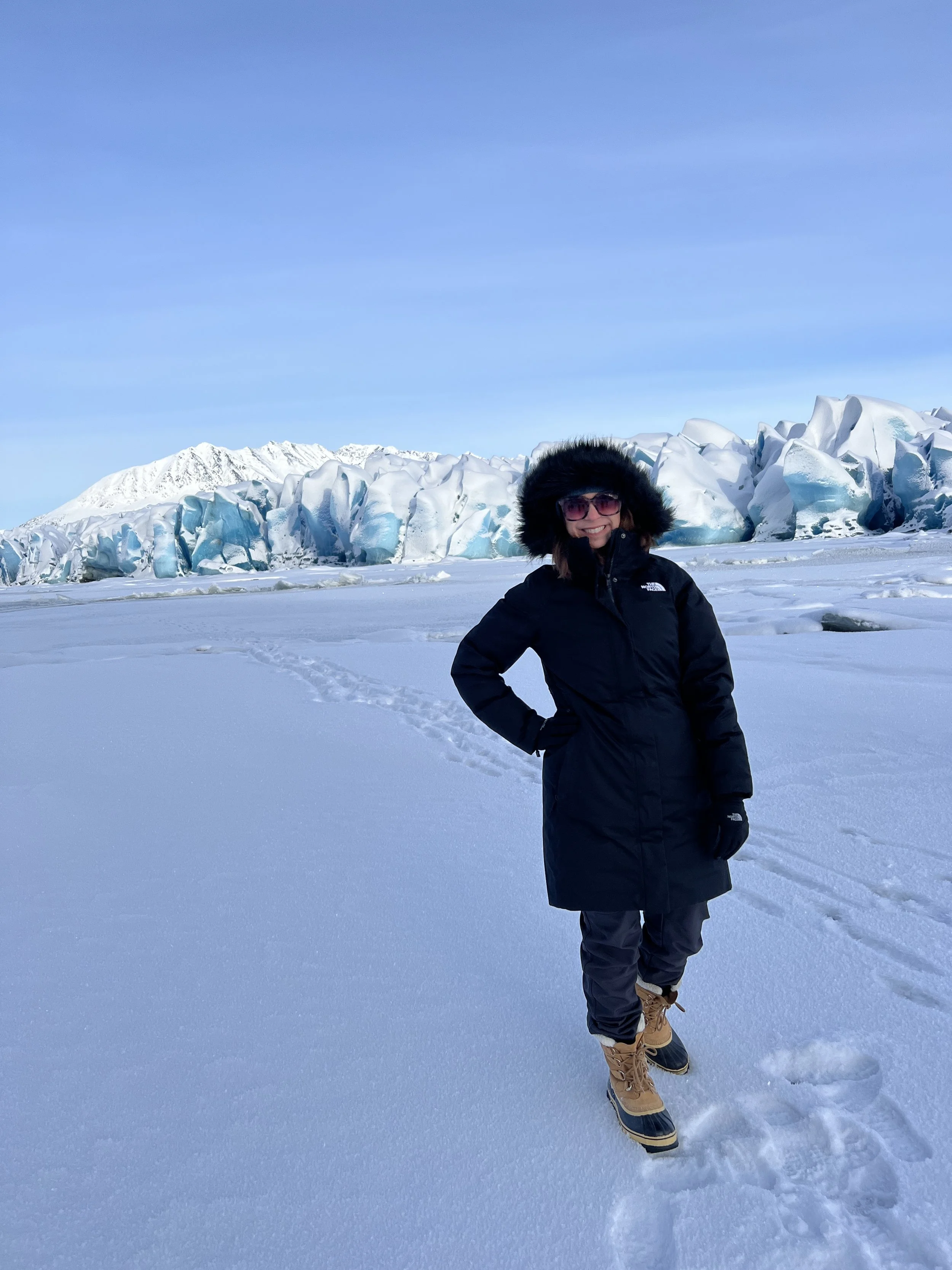 Travel advisor experiencing a glacier during a winter Alaska itinerary, gaining firsthand insight into cold-weather adventure planning.
