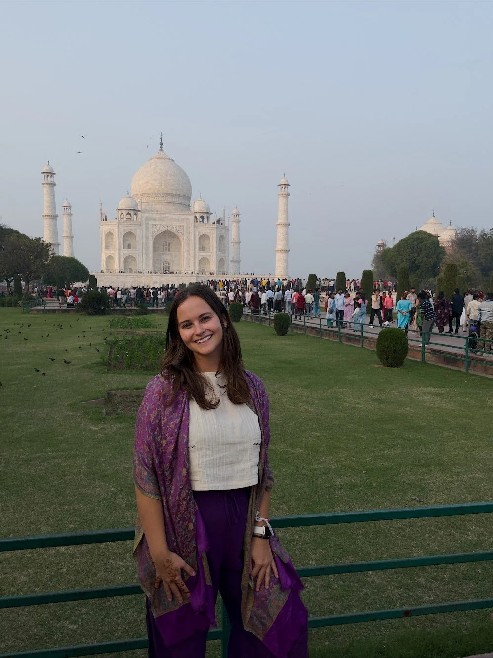 Tourist getting her picture taken, wearing a white shirt.