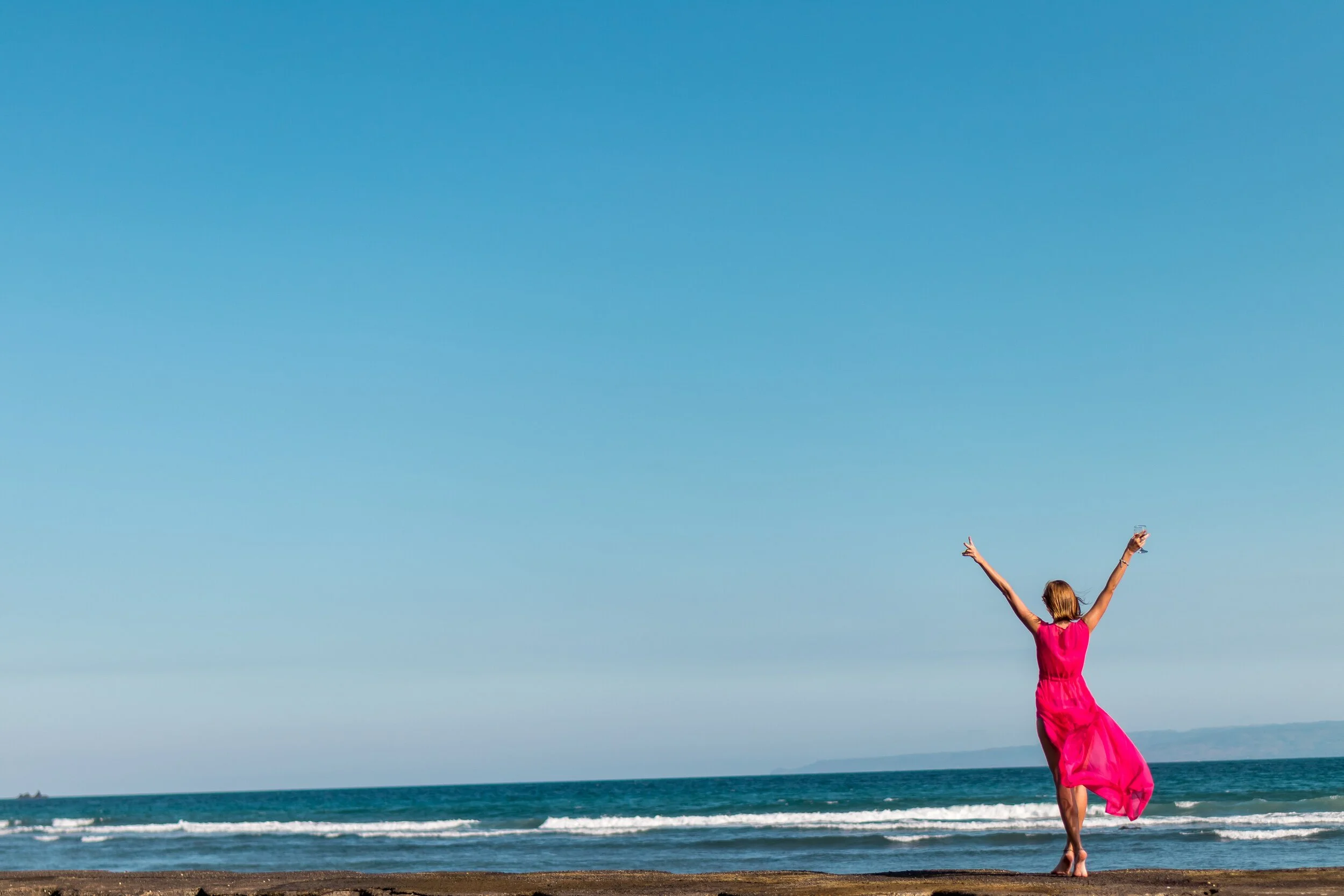 woman-wearing-pink-dress-standing-on-shore-2316088.jpg