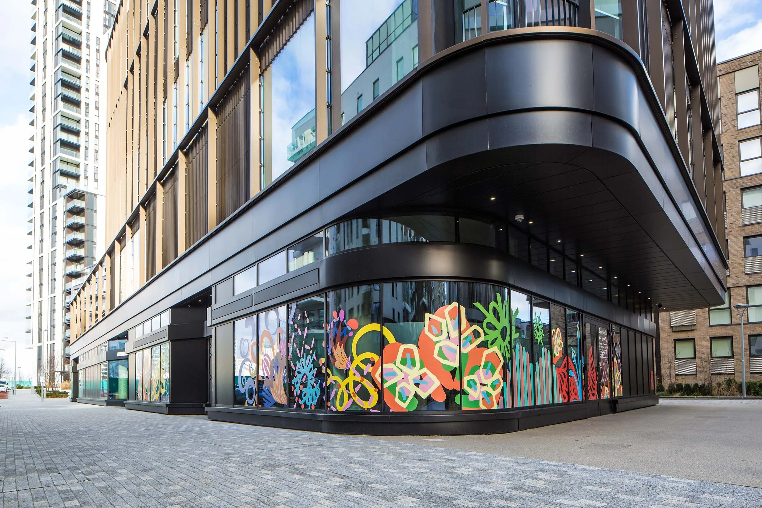 facade vinyl storefront display windows paintings art commission Greenwich Peninsula urban regeneration