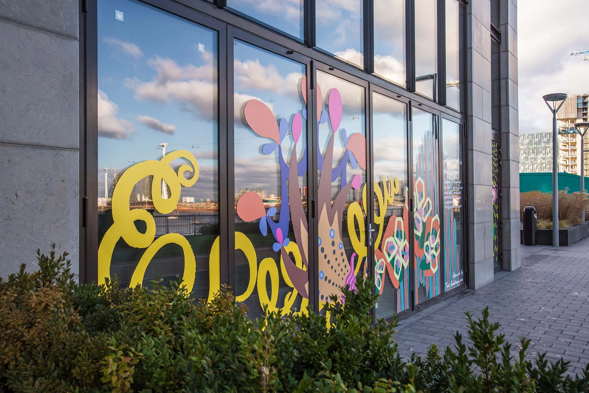 facade vinyl storefront display windows paintings art commission Greenwich Peninsula urban regeneration
