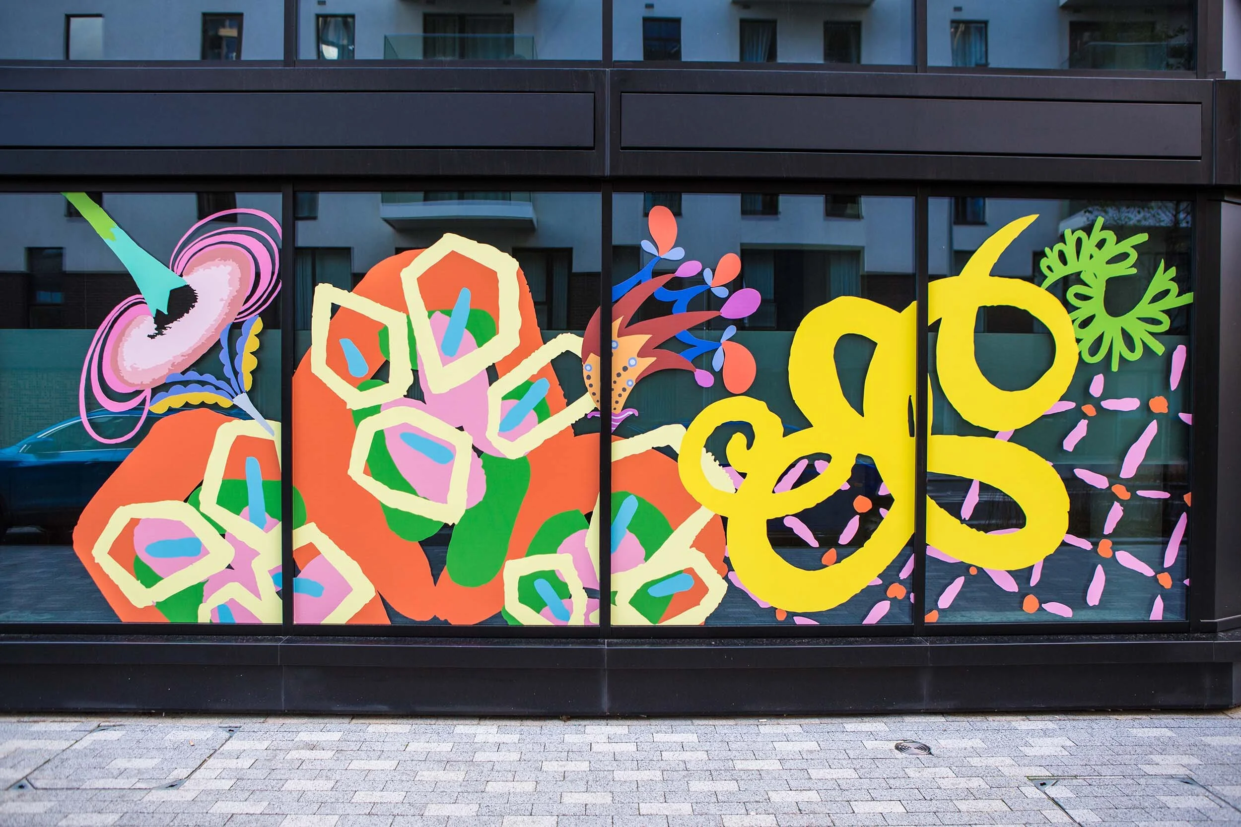 facade vinyl storefront display windows paintings art commission Greenwich Peninsula urban regeneration