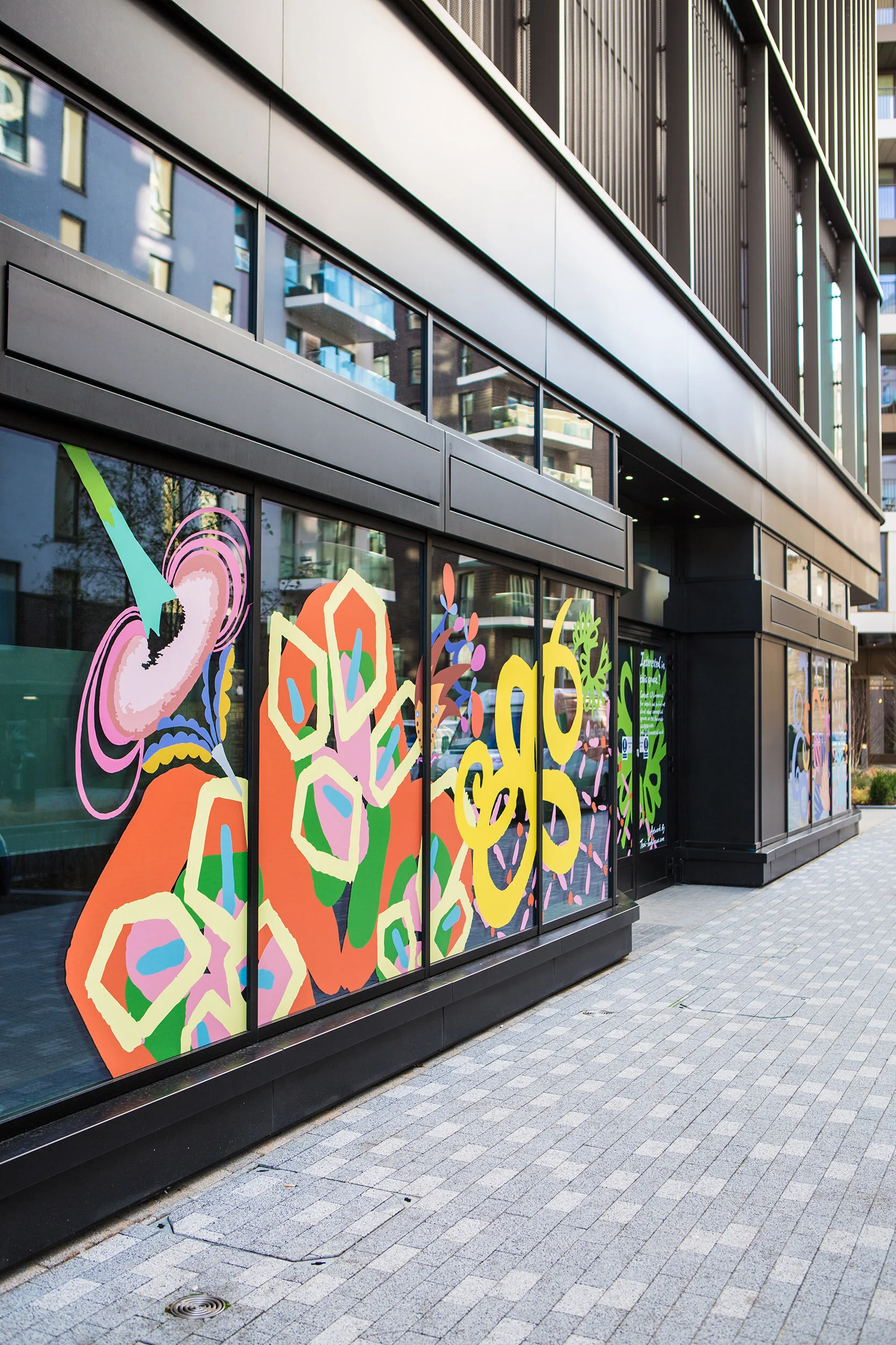 facade vinyl storefront display windows paintings art commission Greenwich Peninsula urban regeneration