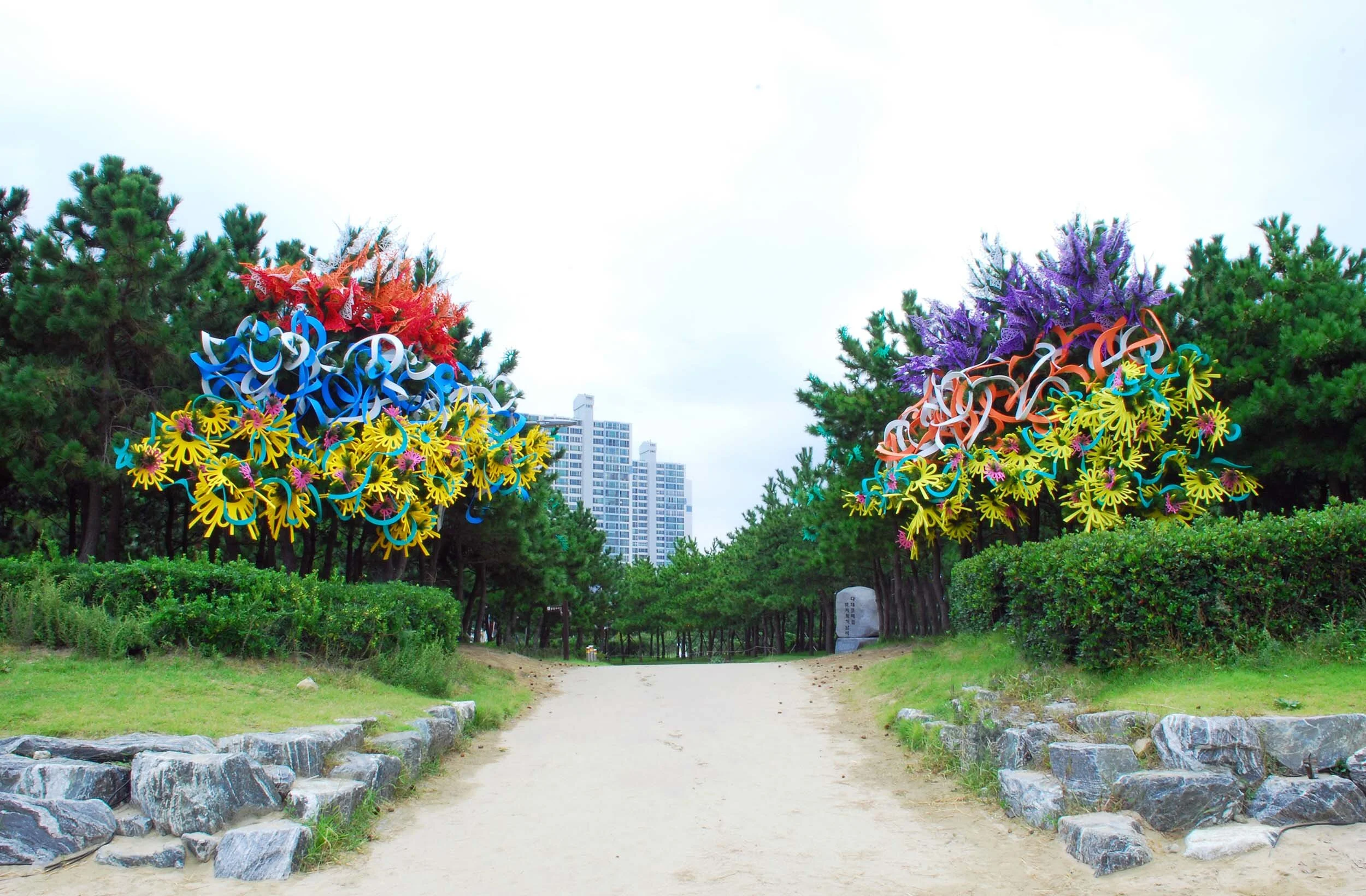 pair outdoor Busan Biennale public art commission beach colorful sculpture installation festival