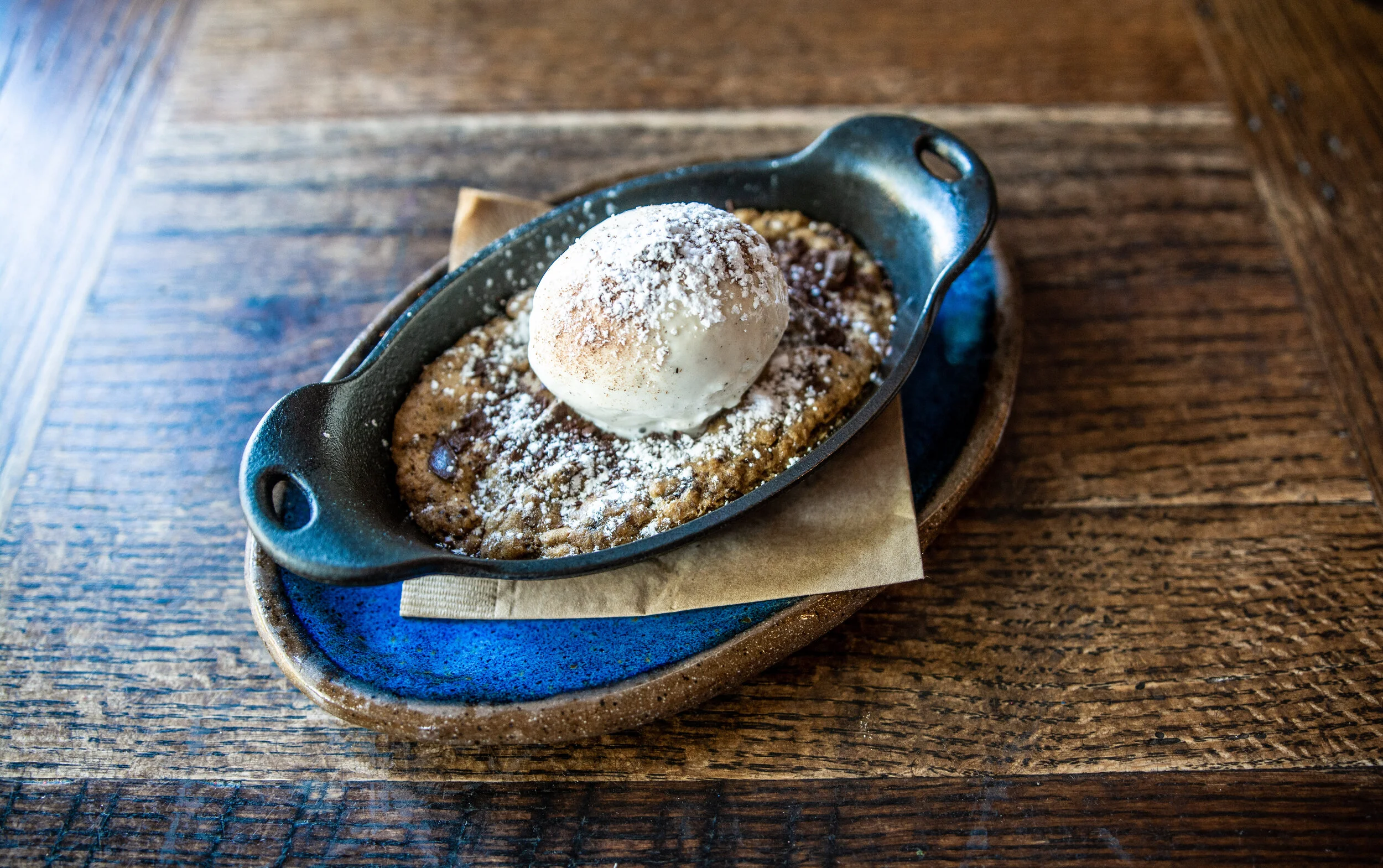 A chocolate chip cookie skillet with a scoop of locally-made vanilla ice cream, available at James Beard Award nominated East Nashville restaurant, Lockeland Table.