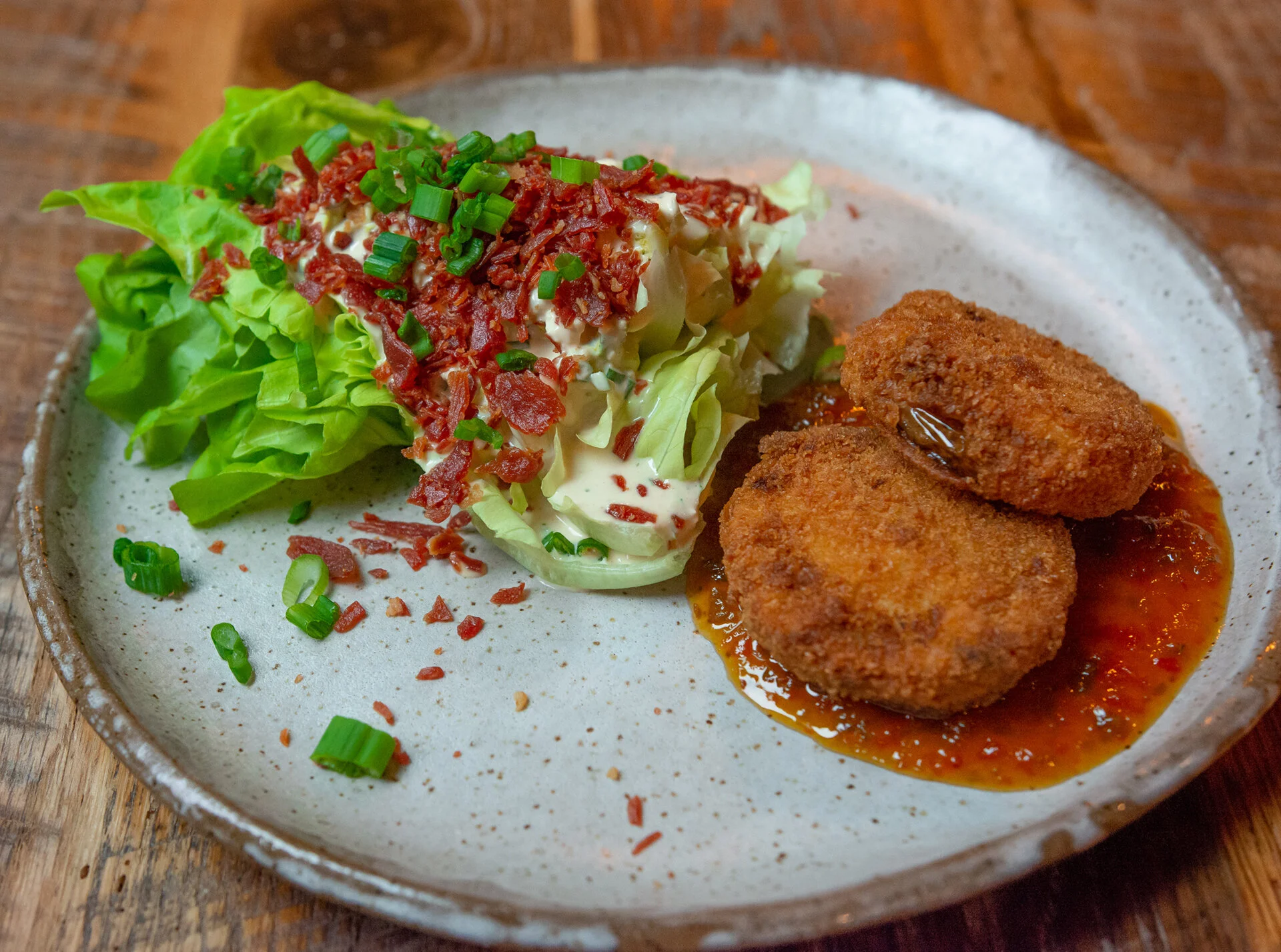 Fried Green Tomatoes next to a fresh wedge salad with dressing and bacon, available at James Beard Award nominated East Nashville restaurant, Lockeland Table.