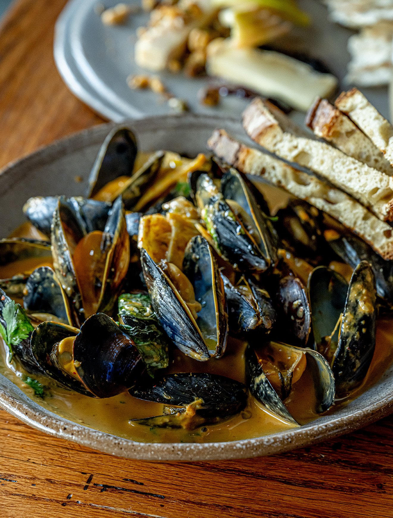 PEI Mussels in a curry broth with fresh-toasted sourdough available at James Beard Award nominated East Nashville restaurant, Lockeland Table. 