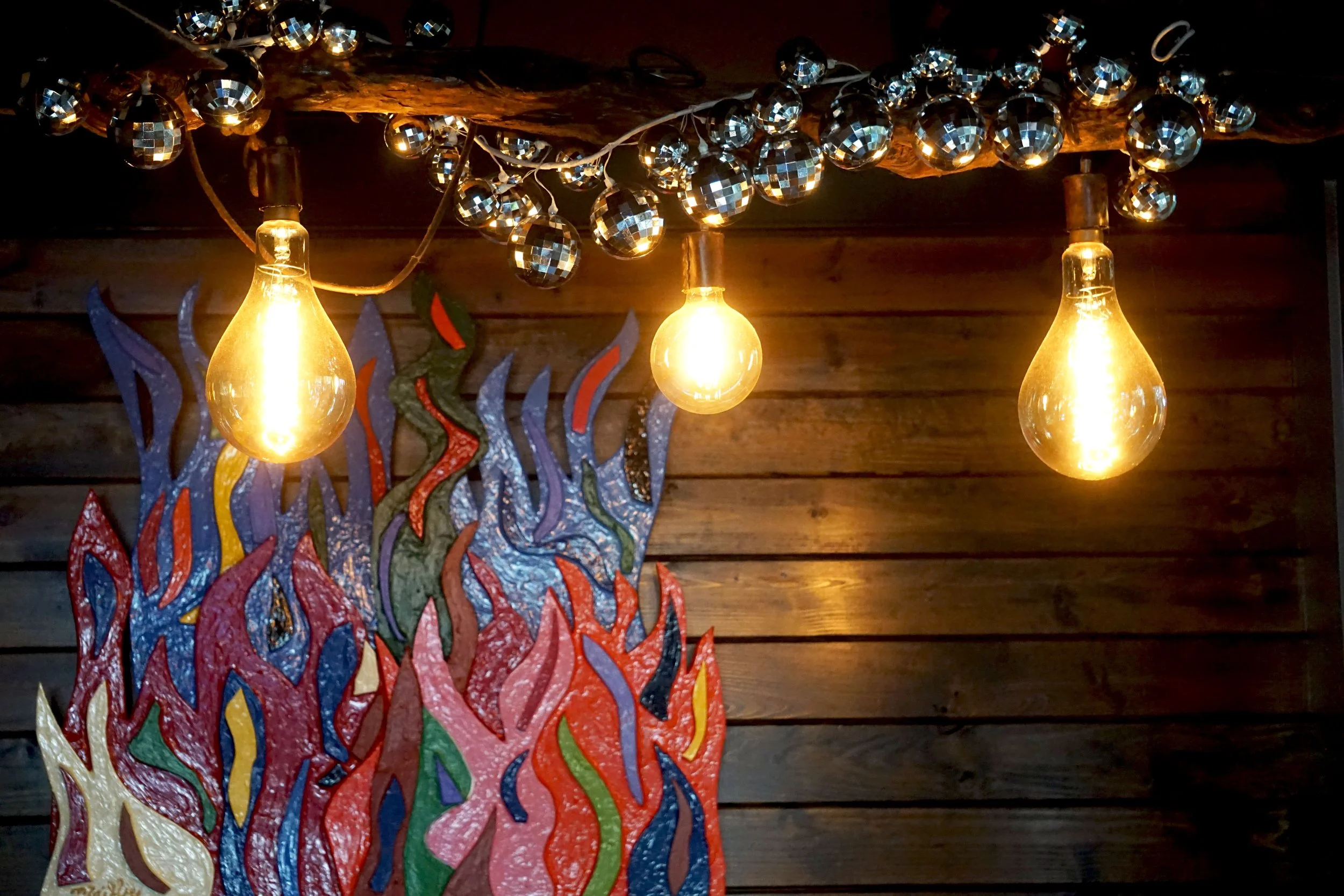  Three lightbulbs with exposed filaments, illustrating the ambience at James Beard Award nominated East Nashville restaurant, Lockeland Table. 