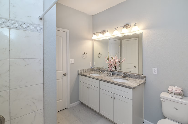 View into master bathroom looking at vanity and standup shower