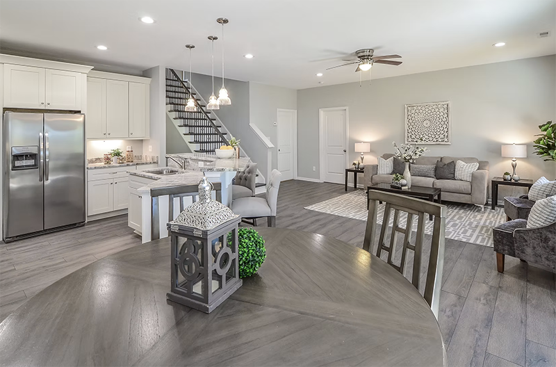 View of living space and kitchen from dining space