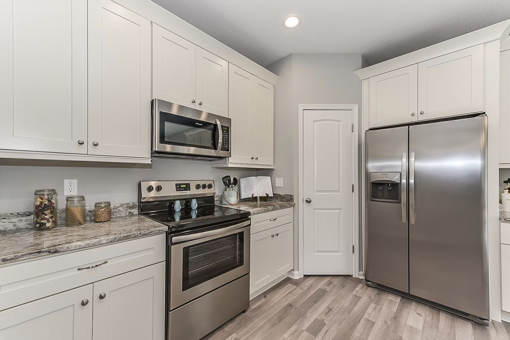 View of kitchen looking at stove and refrigerator