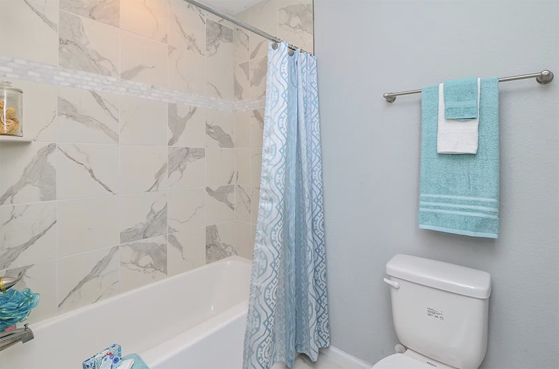 View of hall bathroom looking at shower and toilet