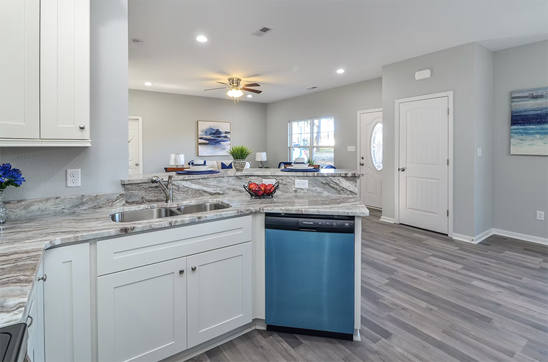 Inside kitchen view looking over bar into living space