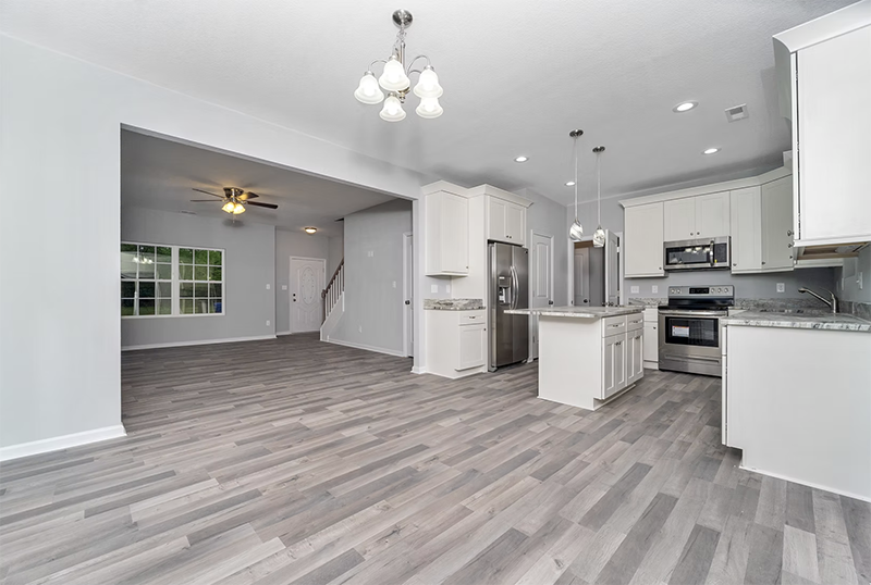 View into kitchen and living space from dining space